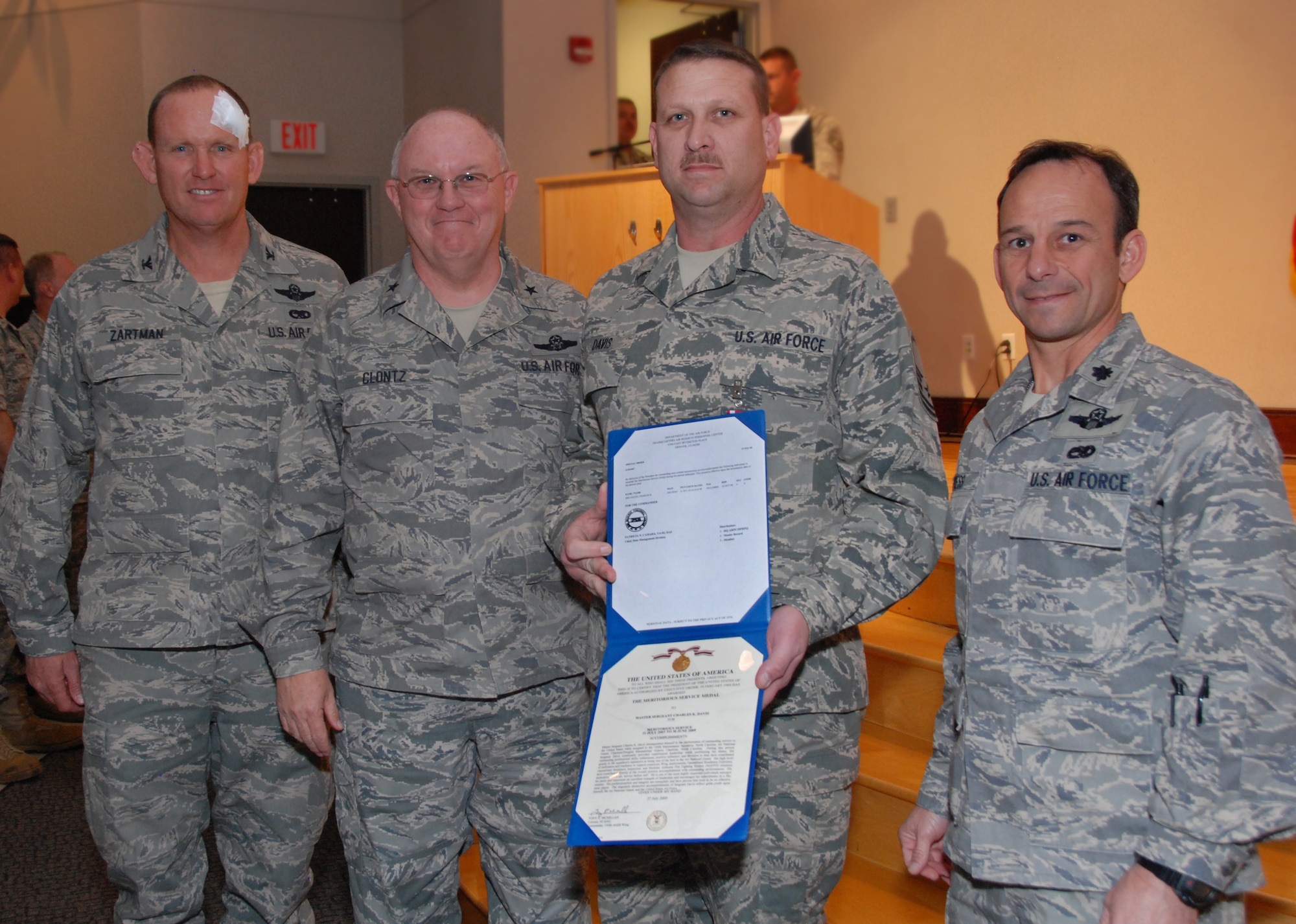 Master Sgt Chuck Davis, NCOIC of the Communications/Navigation section, was one of several Airmen awarded the Air Force meritorious service medal for his leadership and many years of dedication.  Honoring him are Col. David Zartman, Brig. Gen. Iwan Clontz, and Lt. Col. Lance Press. Photo by Master Sgt. Keith Dennis, 145th AW Public Affairs