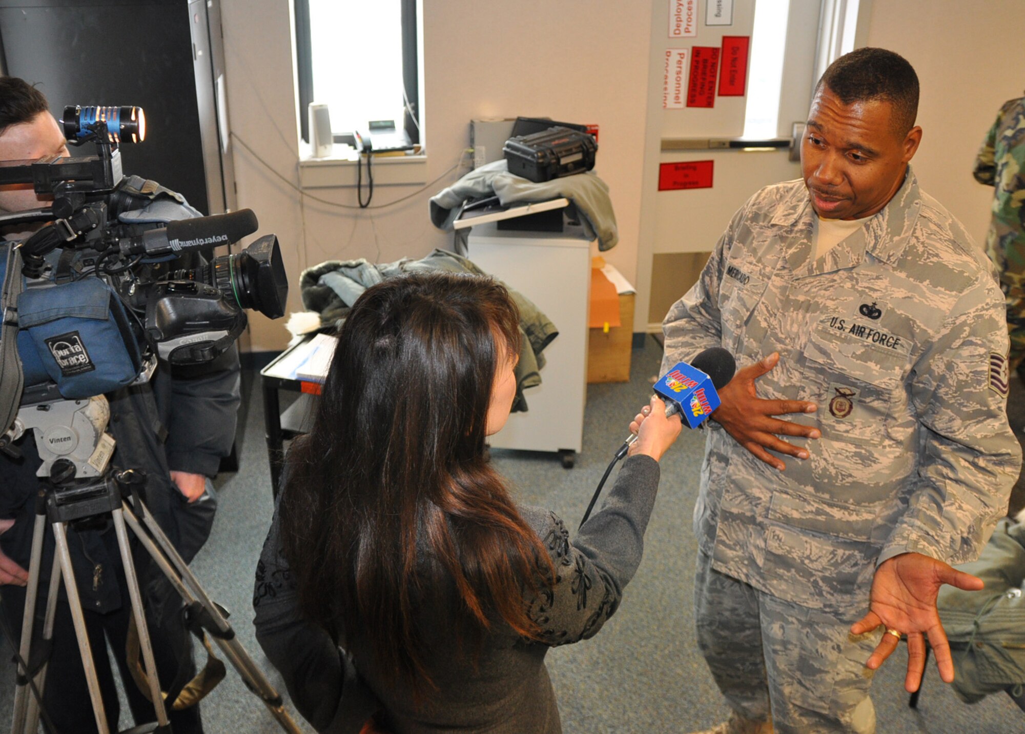 YOUNGSTOWN AIR RESERVE STATION, Oh. — Air Force Reserve Tech. Sgt. Miguel Mercado, a security specialist with the 910th Security Forces Squadron, interviews with WFMJ TV 21 reporter Janet Rogers about his upcoming deployment to Kirkuk AB, Iraq.  He and 12 other Reservists deployed on January 2, 2010 for a six-month rotation to provide air base security in support of Operation Iraqi Freedom.  U. S. Air Force photo/ Maj. Brent J. Davis
