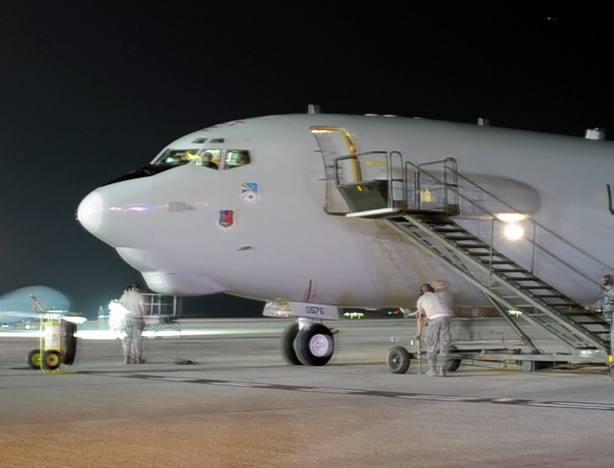 Maintenance Airmen perform post-flight preparation of an E-3 Sentry Airborne Warning and Control System aircraft on the flightline of a non-disclosed base in Southwest Asia on Jan. 10, 2010. The aircraft and Airmen, assigned to the 380th Air Expeditionary Wing, support Operations Iraqi Freedom and Enduring Freedom and the Combined Joint Task Force-Horn of Africa. (U.S. Air Force Photo/Tech. Sgt. Scott T. Sturkol/Released)