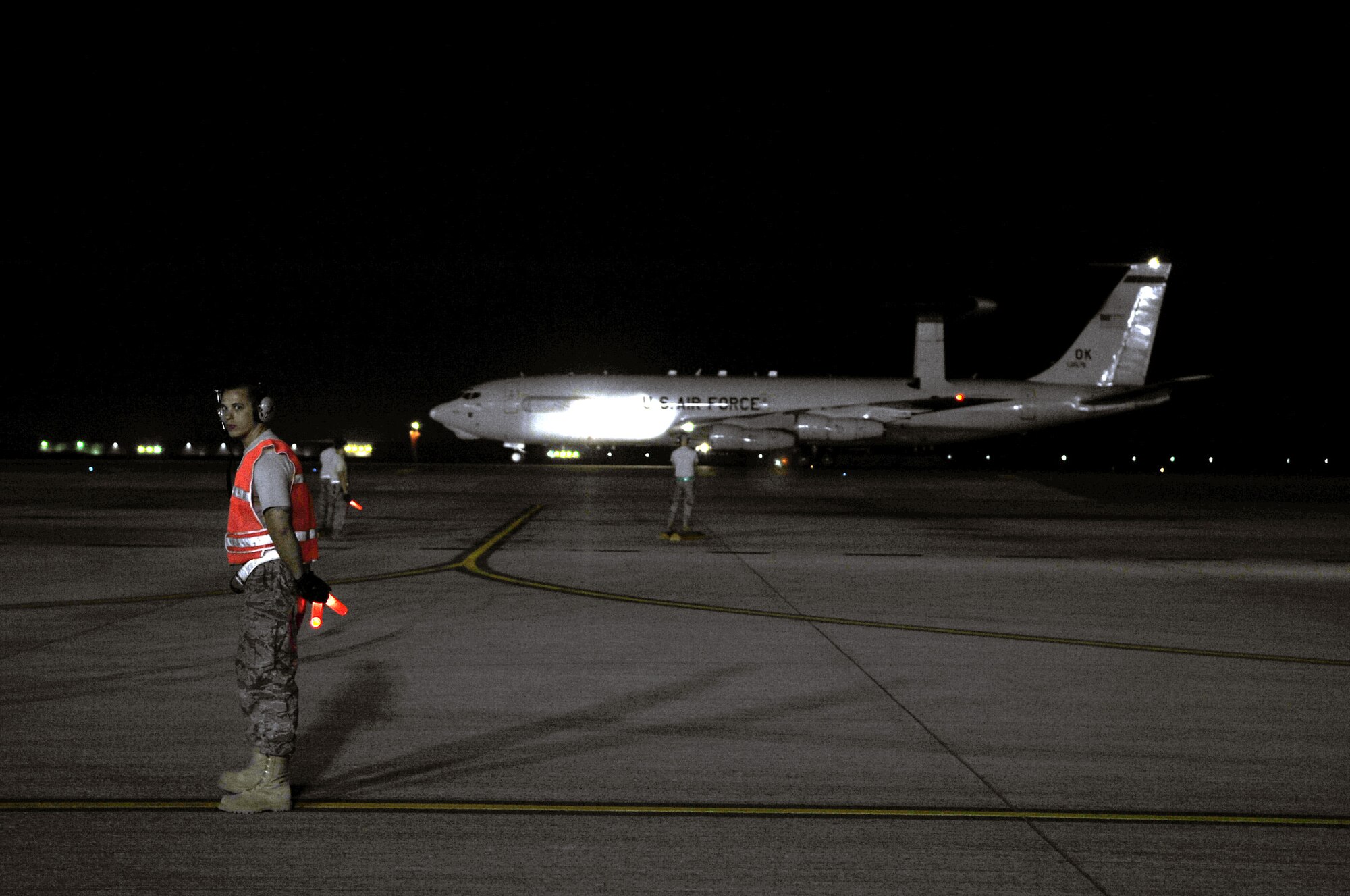 A maintenance Airman waits for an aircraft to come in to park on the flightline of a non-disclosed base in Southwest Asia on Jan. 10, 2010. The aircraft and Airmen, assigned to the 380th Air Expeditionary Wing, support Operations Iraqi Freedom and Enduring Freedom and the Combined Joint Task Force-Horn of Africa. (U.S. Air Force Photo/Tech. Sgt. Scott T. Sturkol/Released)