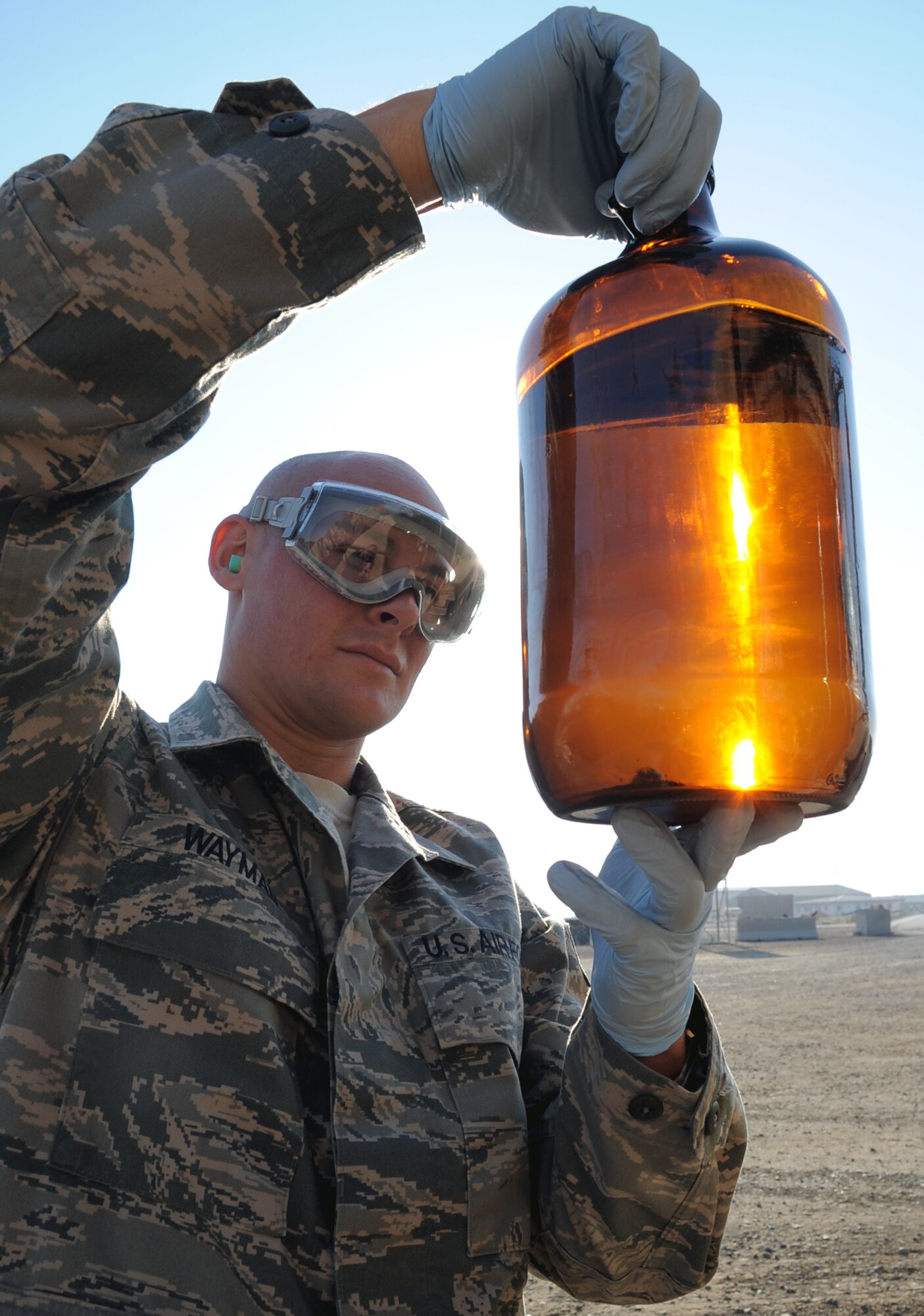 Staff Sgt. Craig Wayman, a fuels labaratory technician with the 380th Expeditionary Logistics Readiness Squadron, checks a sample of fuel from a fuels truck during operations at a non-disclosed base in Southwest Asia on Jan. 6, 2010. The 380th ELRS fuels management flight pumps millions of gallons of fuel every month is support of Operations Iraqi Freedom and Enduring Freedom and the Combined Joint Task Force-Horn of Africa. Sergeant Wayman is deployed from the 9th LRS at Eglin Air Force Base, Fla., and his hometown is Worcester, Mass. (U.S. Air Force Photo/Tech. Sgt. Scott T. Sturkol)