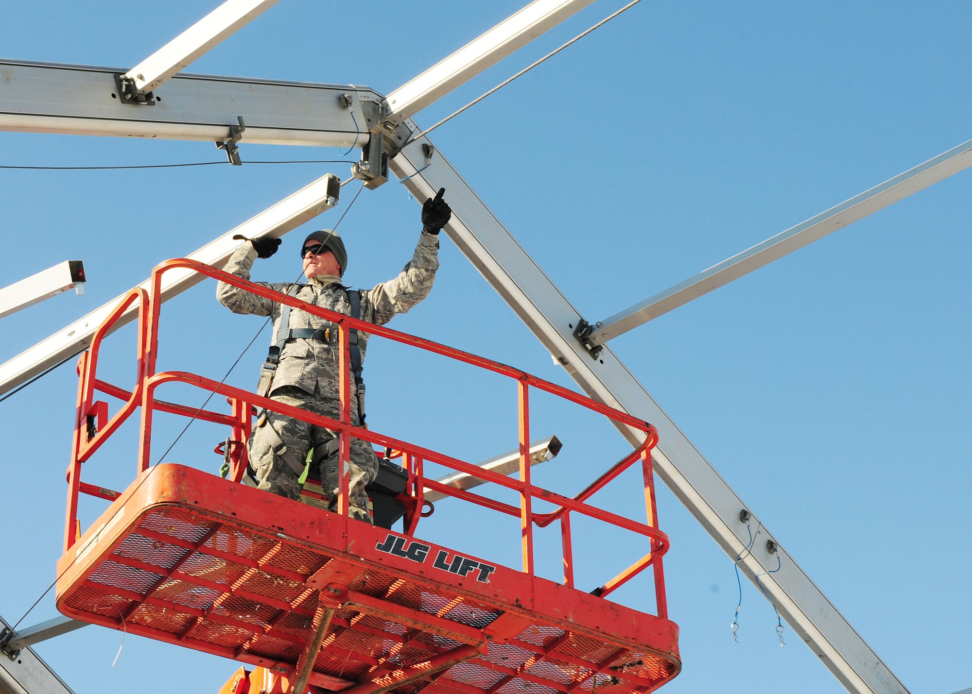 TRANSIT CENTER AT MANAS, Kyrgyzstan - Tech. Sgt. Thomas Sampson U.S. Air Forces Central Forward Construction Office A-7, connects support beams for a new 4K Dome tent here Jan. 11. The new tents are being built to support the influx of Airmen, Soldiers, Sailors and Marines who pass through the TC en route to Afghanistan.  Sergeant Sampson is deployed from the 49th Material Maintenance Squadron, Holloman Air Force Base, N.M. (U.S. Air Force photo by Senior Airman Nichelle Anderson)