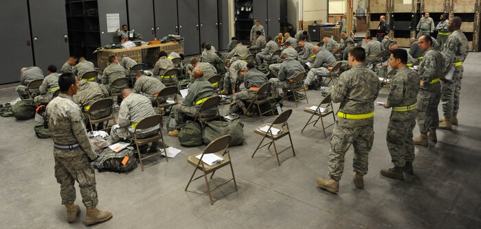 NELLIS AIR FORCE BASE, Nev. -- Airmen from the 99th Air Base Wing simulate deploying at the deployment center during an operational readiness exercise Dec. 21. The 99th ABW is preparing for an operation readiness inspection Jan 25-29. (U.S. Air Force photo by Airman 1st Class Bret Clashman)