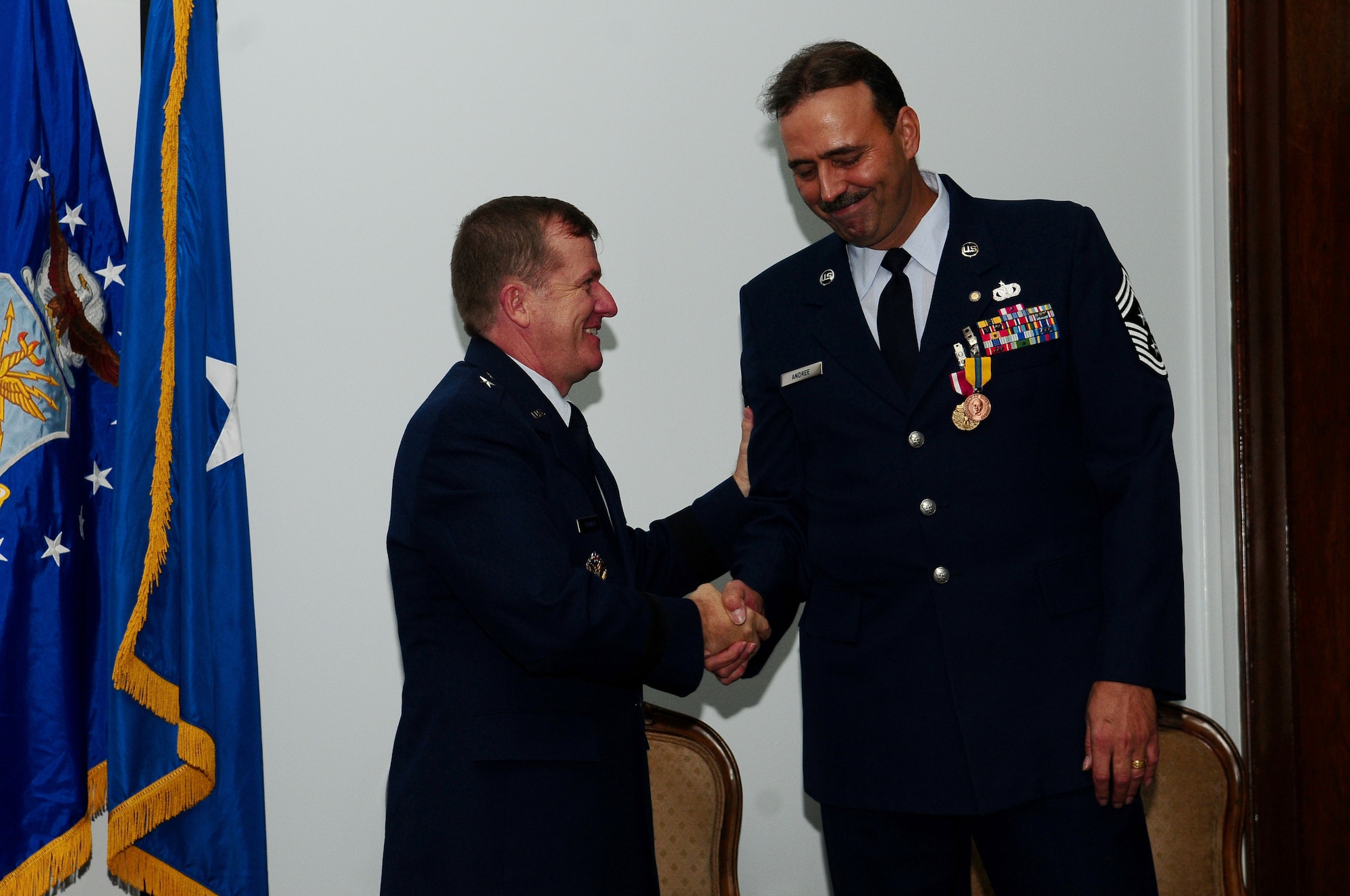 ANDERSEN AIR FORCE BASE Guam:  Gen. Phil Ruhlman, 36th Wing commander,  congratulates 36th Wing Command Chief Master Sergeant Saniford D. "Bud" Andree, Jr., on his career and achievements during a retirement ceremony,Jan. 8 at the Sunrise Conference Center. Before retiring, Chief Andree hands over the reins of command chief ofthe 36th Wing to Chief Master Sgt. Allen Mullinex. (U.S. Air Force photo by Airman 1st Class Jeffrey Schultze)