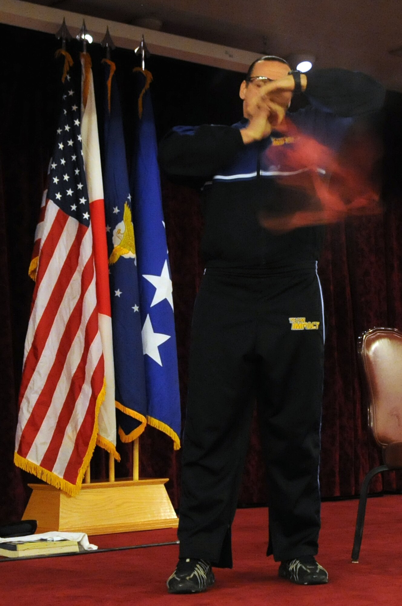 Team Impact member Jeff Neal blows up a hot water bottle in a display of personal strength, Jan. 12. Team Impact was the featured presentation at Kadena’s 2010 observance of the National Prayer Breakfast. (US Air Force photo/Staff Sgt. Christopher Hummel)