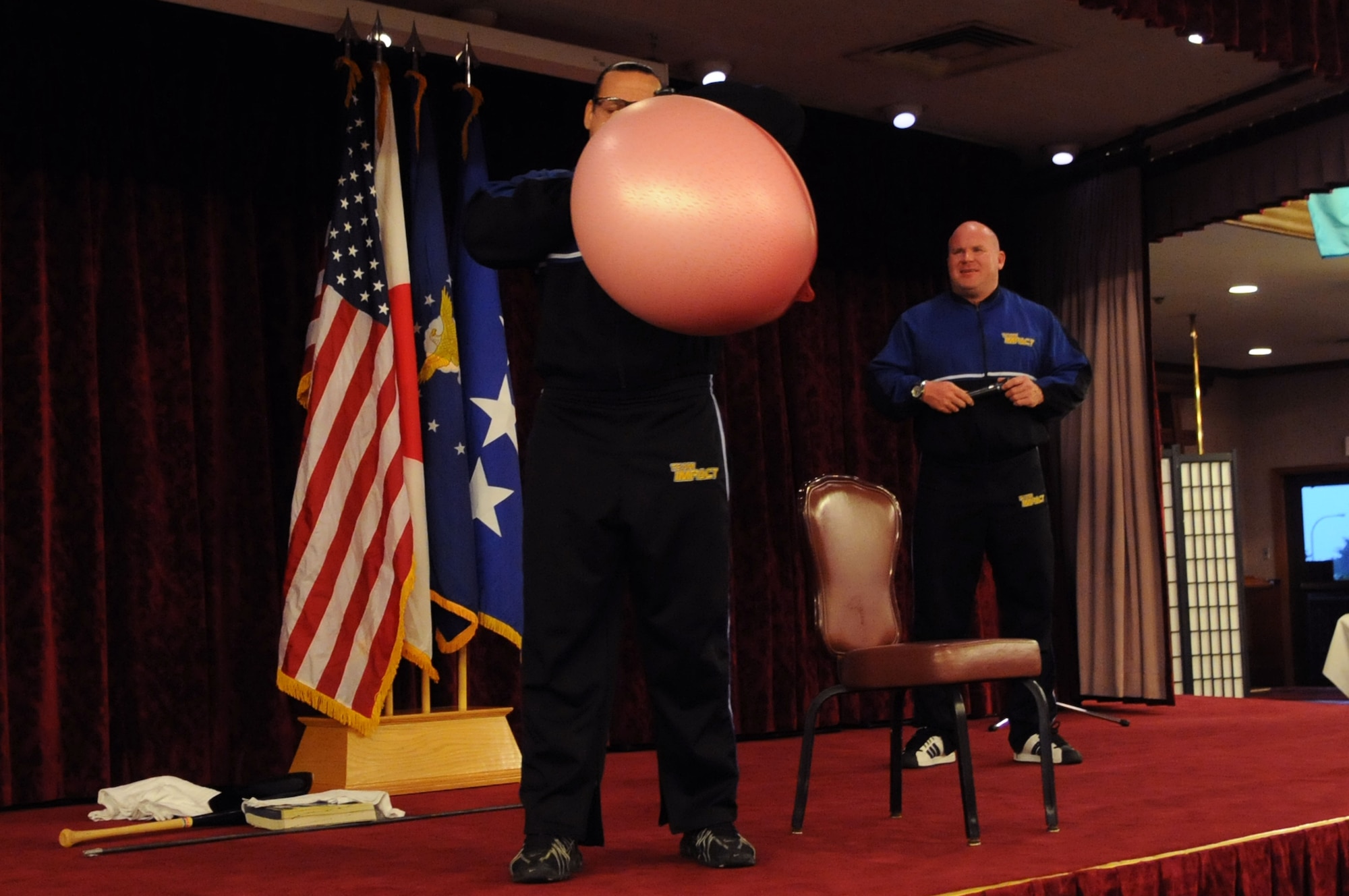 Team Impact member Jeff Neal blows up a hot water bottle in a display of personal strength, Jan. 12. Team Impact was the featured presentation at Kadena’s 2010 observance of the National Prayer Breakfast. (US Air Force photo/Staff Sgt. Christopher Hummel)