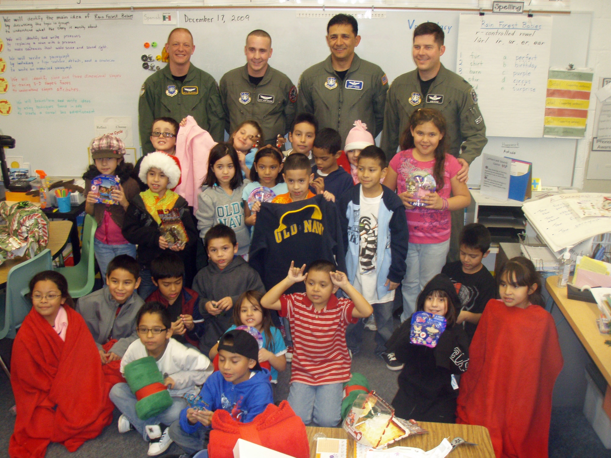 BOULDER, Colo. -- Volunteers from 460th Operations Group Detachment 1 pose with second-graders from Alsup Elementary in Commerce City, Colo. Dec. 17, 2009, after their gift drive. The volunteers raised $3,600 for blankets, sweatshirts and toys for each student as well as school supplies, playground equipment and a $250 gift card for the teachers. (U.S. Air Force photo)