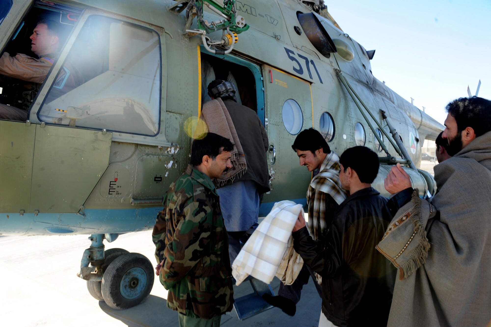 Afghanistan National Army Air Corp soldiers board an Mi-17 helicopter Jan. 7, 2010, at Kandahar Airfield, Afghanistan. Missions like this are becoming more common as 441st Air Expeditionary Advisory Squadron Airmen continue empowering Afghans to provide their own security by mentoring MI-17 helicopter pilots. The Mi-17 helicopter is piloted by 441st Air Expeditionary Advisory Squadron mentors and ANAAC pilots. (U.S. Air Force photo/Staff Sgt. Manuel J. Martinez)
