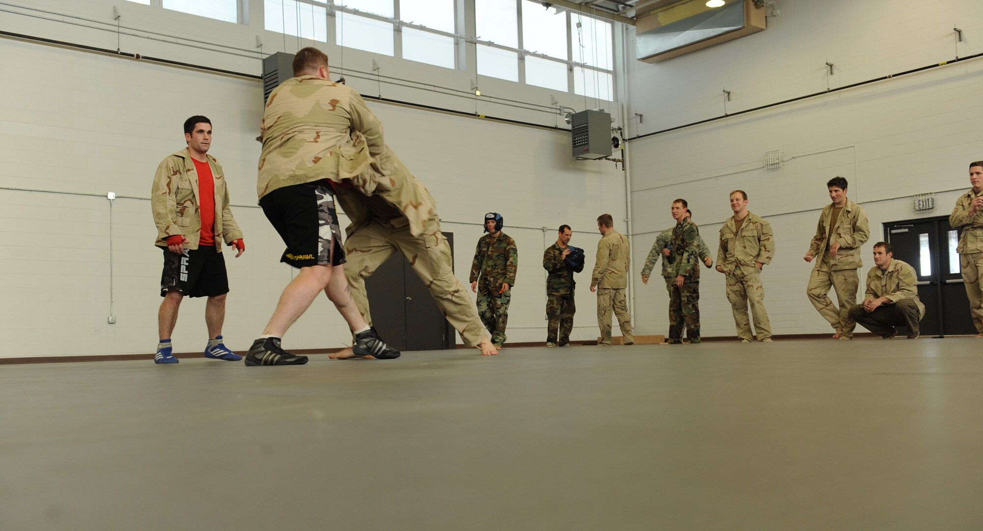 MOODY AIR FORCE BASE, Ga. -- Tech. Sgt. Joseph Signor, 38th Rescue Squadron pararescueman, bravo flight NCO in-charge, grapples with Staff Sgt. Justin McCaffrey, 38th Rescue Squadron Survival, Evasion, Resistance, and Escape specialist NCO in-charge, as other members of the 38th RQS wait for their turn on the mat during the Modern Army Combatives Program training here Jan. 7. The MAC-P teaches the use of deadly force with or without a weapon and it is a mandatory requirement for all pararescuemen to be certified in this training. (U.S. Air Force photo by Airman 1st Class Benjamin Wiseman)