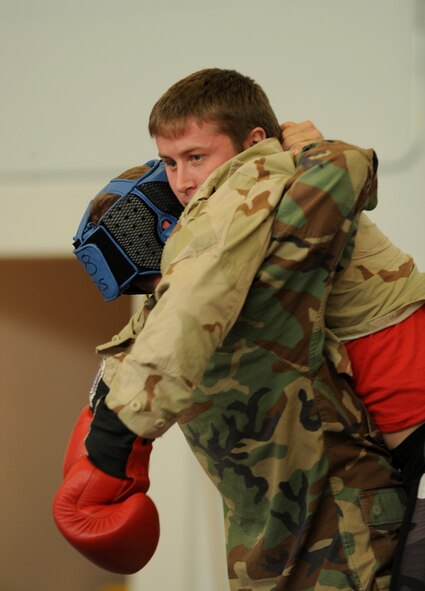 MOODY AIR FORCE BASE, Ga. -- Senior Airman Joseph Dittmer, 347th Operations Support Squadron Survival, Evasion, Resistance and Escape specialist, is placed in a clinch position by a member of the 38th Rescue Squadron during the Modern Army Combatives Program training here Jan. 7. The MAC-P training teaches techniques that can be used to kill or render an enemy helpless during hand-to-hand combat. (U.S. Air Force photo by Airman 1st Class Benjamin Wiseman)