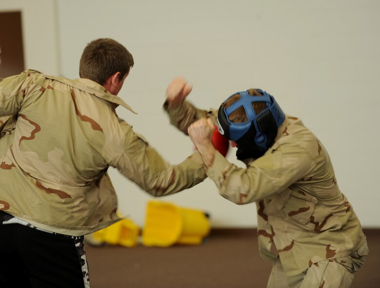 MOODY AIR FORCE BASE, Ga. -- Senior Airman Joseph Dittmer, 347th Operations Support Squadron Survival, Evasion, Resistance and Escape specialist, throws a punch at a member of the 38th Rescue Squadron during the Modern Army Combatives Program training here Jan. 7. Airman Dittmer is one of three SERE instructors who is trained to teach the MAC-P. (U.S. Air Force photo by Airman 1st Class Benjamin Wiseman)