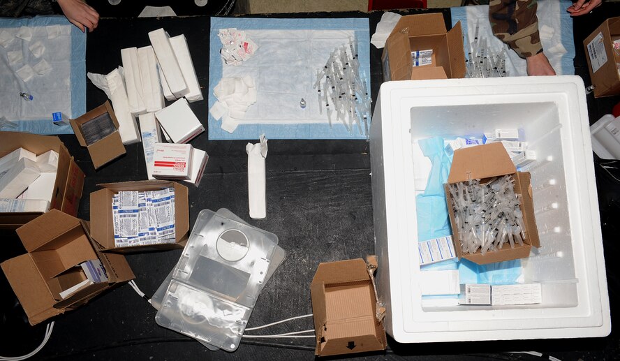 MOODY AIR FORCE BASE, Ga. -- Airmen from the 23rd Medical Group prepare supplies needed to administer the H1N1 influenza vaccination during a mass immunization event here Jan. 8. H1N1 Influenza, commonly known as the swine flu, is a respiratory disease caused by type A influenza viruses. (U.S. Air Force photo by Airman 1st Class Joshua Green)
