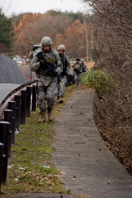 MISAWA AIR BASE, Japan -- Members of the 35th Civil Engineer Squadron Explosive Ordnance Disposal flight march along Concrete Canyon Jan. 8 during a ruck march. Ruck marches are part of the flight's pre-deployment training, preparing members for dismounted-patrol support while in various austere landscapes. (U.S. Air Force photo/Senior Airman Jamal D. Sutter) 
