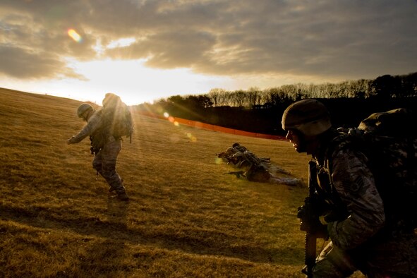 MISAWA AIR BASE, Japan -- Members of the 35th Civil Engineer Squadron Explosive Ordnance Disposal flight conduct a bounding drill during a ruck march Jan. 8 while ascending Suicide Hill. The drill demonstrated a firing tactic where one group makes their way uphill, while another group engages enemy positions. The responsibilities of the groups alternated until both reached their final position. (U.S. Air Force photo/Senior Airman Jamal D. Sutter) 
