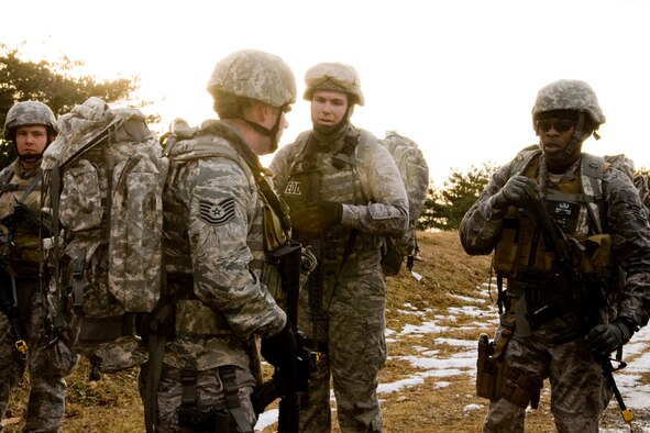 MISAWA AIR BASE, Japan -- Members of the 35th Civil Engineer Squadron Explosive Ordnance Disposal flight discuss transition drill tactics during a ruck march Jan. 8. The flight performed numerous drills during the march, which demanded cooperation from team members. (U.S. Air Force photo/Senior Airman Jamal D. Sutter) 
