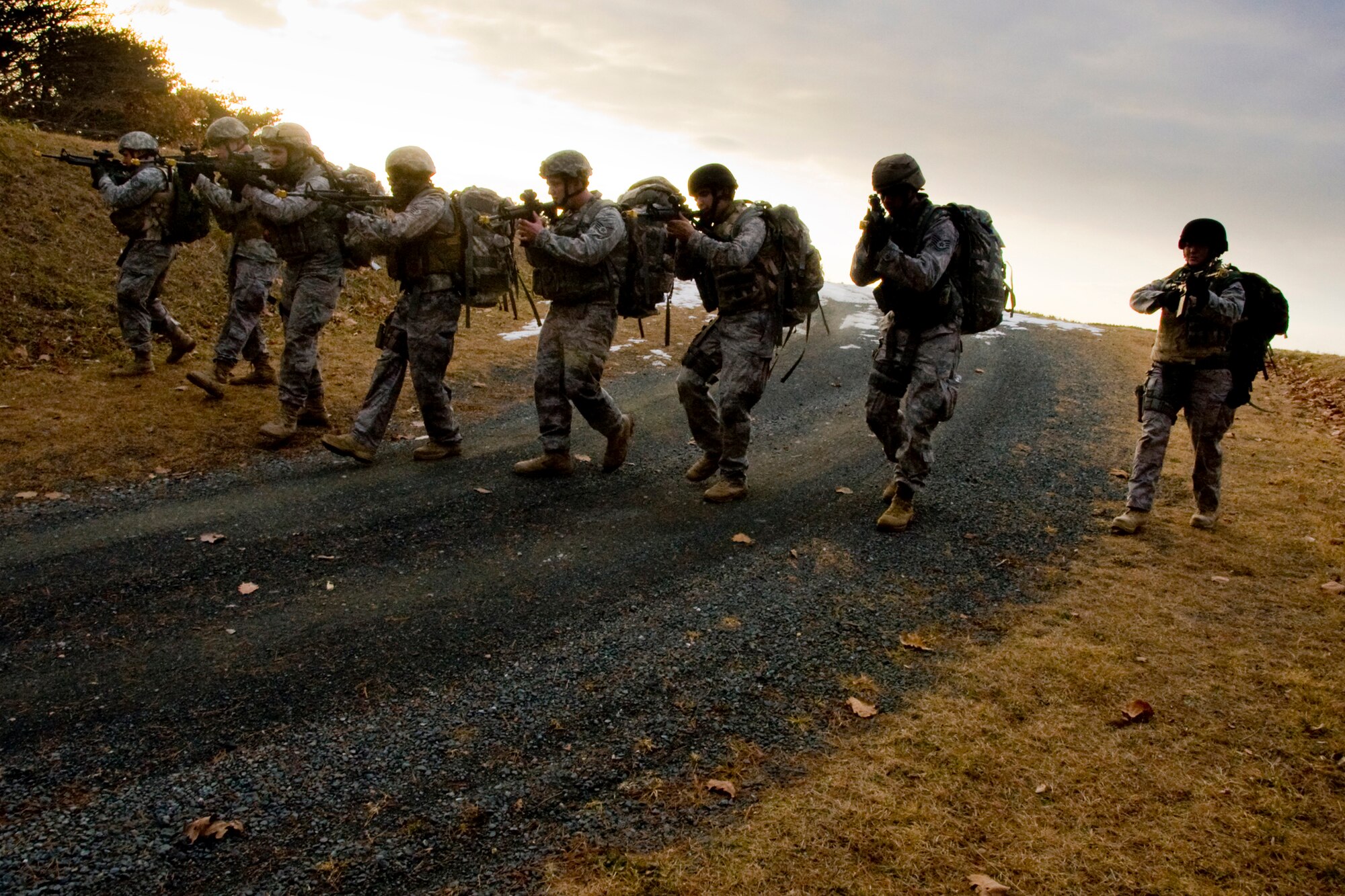 MISAWA AIR BASE, Japan -- Members of the 35th Civil Engineer Squadron Explosive Ordinance Disposal flight perform a transition drill Jan. 8 during a ruck march. The drill trained members on the proper way to transition from a primary weapon to a secondary weapon. (U.S. Air Force photo/Senior Airman Jamal D. Sutter)