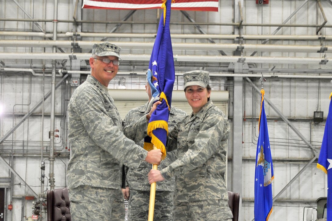 Lt. Gen. Robert Allardice passes the guidon to Col. Martha Meeker during the 628th Air Base Wing activation and assumption-of-command ceremony Jan. 8 at Charleston Air Force Base, S.C.. The activation of the 628th ABW is the first step in fulfilling the 2005 Base Realignment and Closure decision that forms Joint Base Charleston. General Allardice is the 18th Air Force commander and Colonel Meeker is the 628th ABW commander. (U.S. Air Force photo/Staff Sgt. Marie Brown)