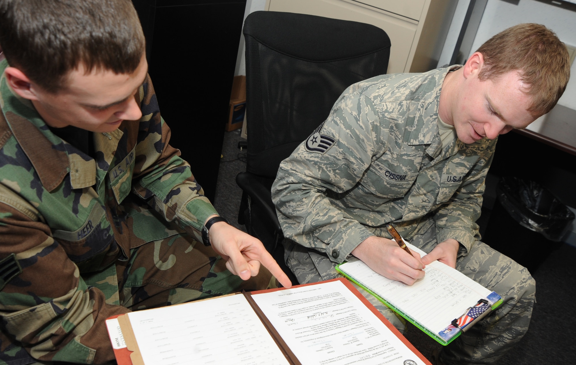 Senior Airman Daylan Heer and Staff Sgt. Jonathan Cissna, 22nd Communications Squadron, review an inventory of computer-user accounts to update information and ensure the list follows proper documentation procedures, Dec. 28, 2009, in the information technology asset management office at McConnell Air Force Base, Kan. The asset management office controls and accounts for communication assets base-wide. (U.S. Air Force Photo/Senior Airman Ruiz)