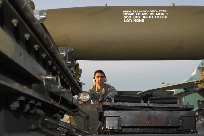NELLIS AIR FORCE BASE, Nev.-- Airman 1st Class Gilbert Melendez, a weapons loader, 57th Aircraft Maintenance Squadron, prepares to pick up a MK-82 LD off of a MHU-141 trailer during the load crew competition here Jan. 8.  The quarterly weapons load crew competition tests the skills of airman on six different teams. The Airmen are judged on speed, accuracy and safety. (U.S Air Force photo by Staff Sgt. Taylor Worley)(Released)
