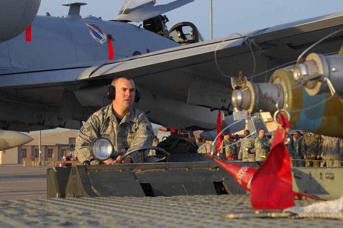 NELLIS AIR FORCE BASE, Nev.-- Senior Airman Justin Sherron, a weapons loader, 57th Aircraft Maintenance Squadron lines up to transport a MK-82 LD from a MHU-141 trailer to the A-10C Thunderbolt during the load team competition here Jan. 8.  The quarterly weapons load crew competition tests the skills of airman on six different teams. The Airmen are judged on speed, accuracy and safety. (U.S Air Force photo by Staff Sgt. Taylor Worley)(Released)
