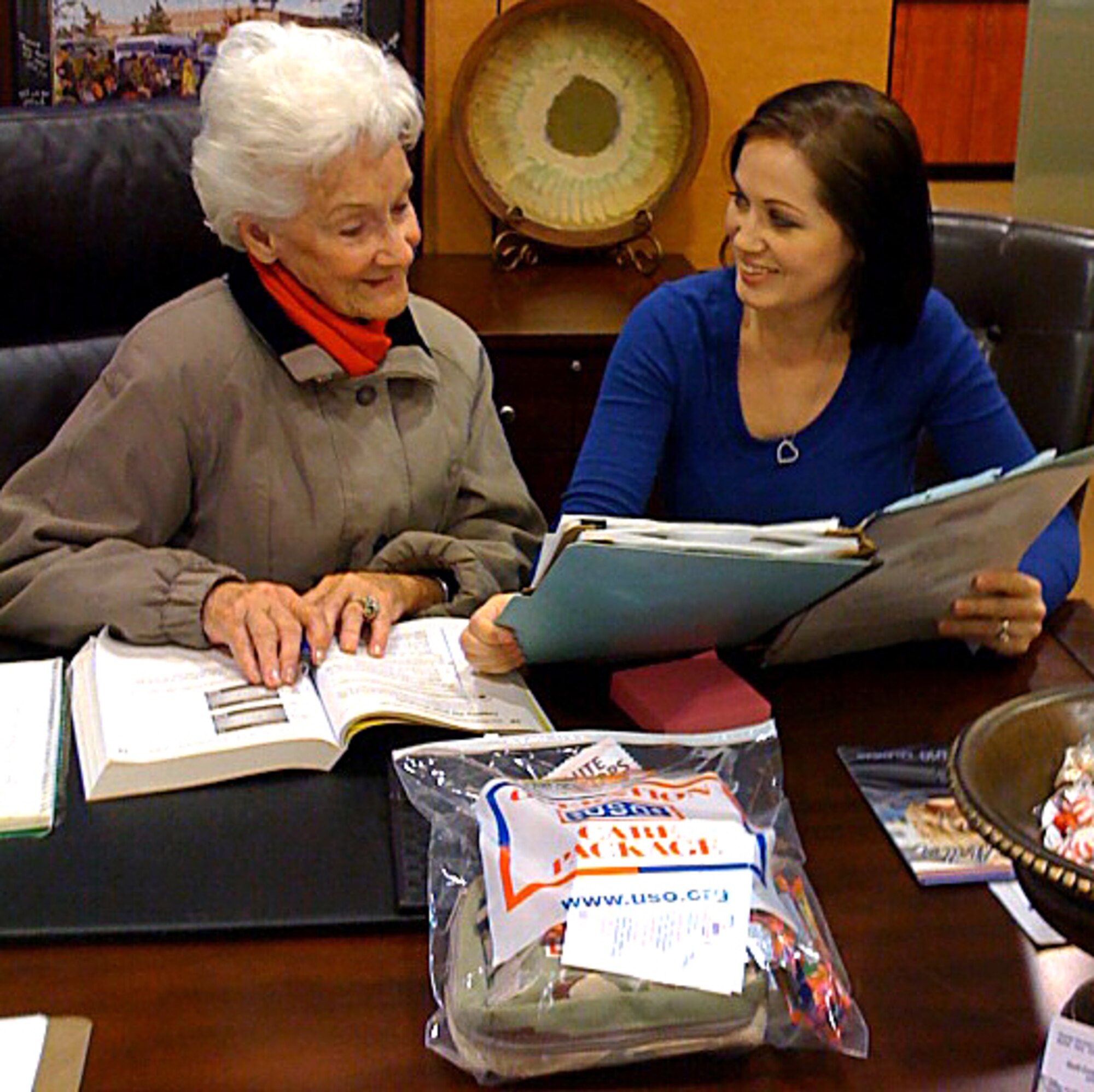USO Gulf Coast director Deanna Attaway discusses the distribution of care packages for upcoming deployments with Dr. Mary Elizabeth Stevens, a volunteer at the USO lounge at the Gulfport-Biloxi International Airport. (Courtesy photo)