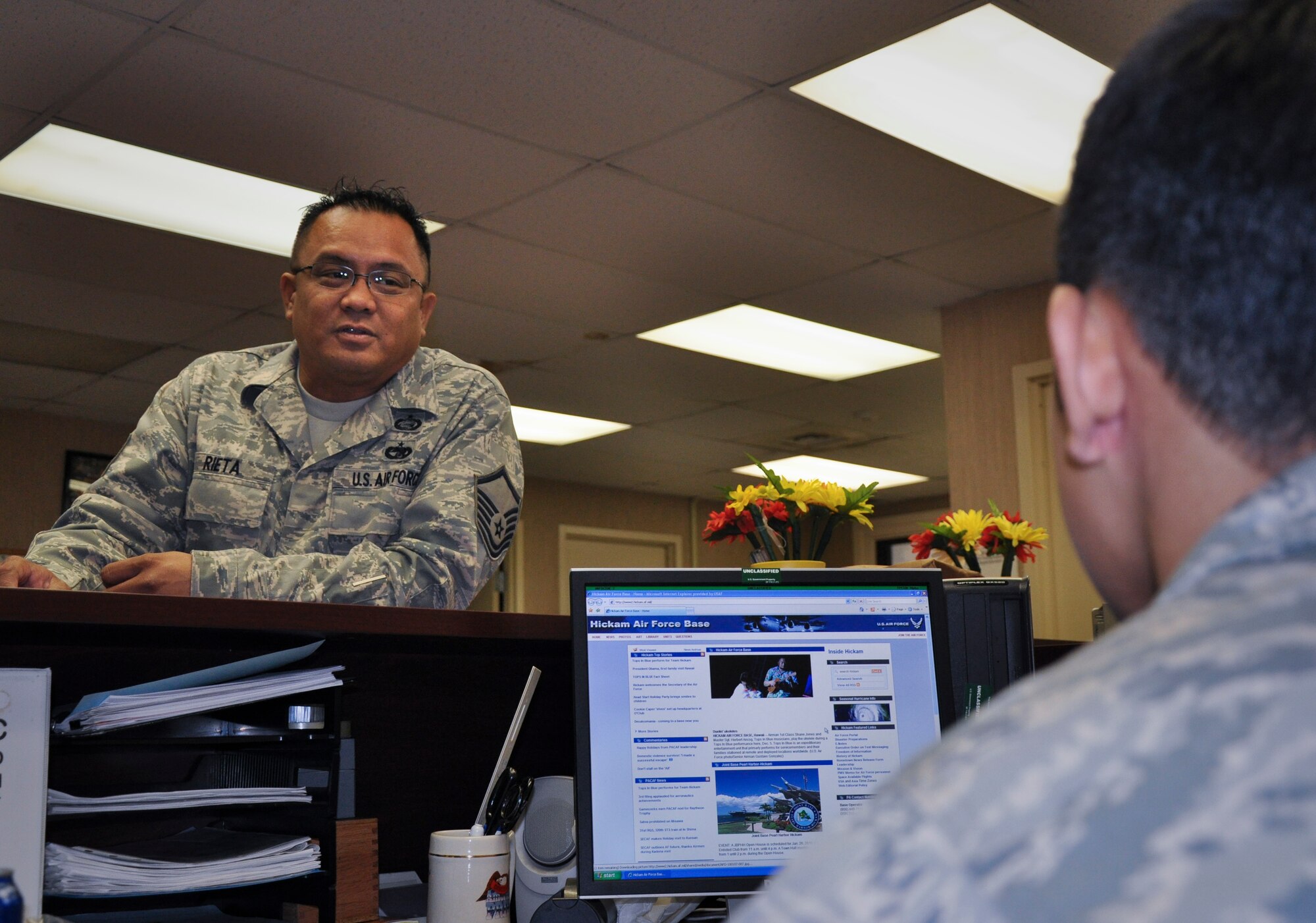 Master Sgt. Peter Rieta, 48th Aerial Port Squadron, training manager, discusses training requirements with Senior Airman Ryan Kanagusuku, one of his Airmen in the unit. Sergeant Rieta was promoted to Master Sergeant under the Promotion Enhancement Program. He stresses the importance of Professional Military Education and the Community College of the Air Force degree to the Airmen in his unit. (U.S. Air Force photo/Staff Sgt. Erin Smith)