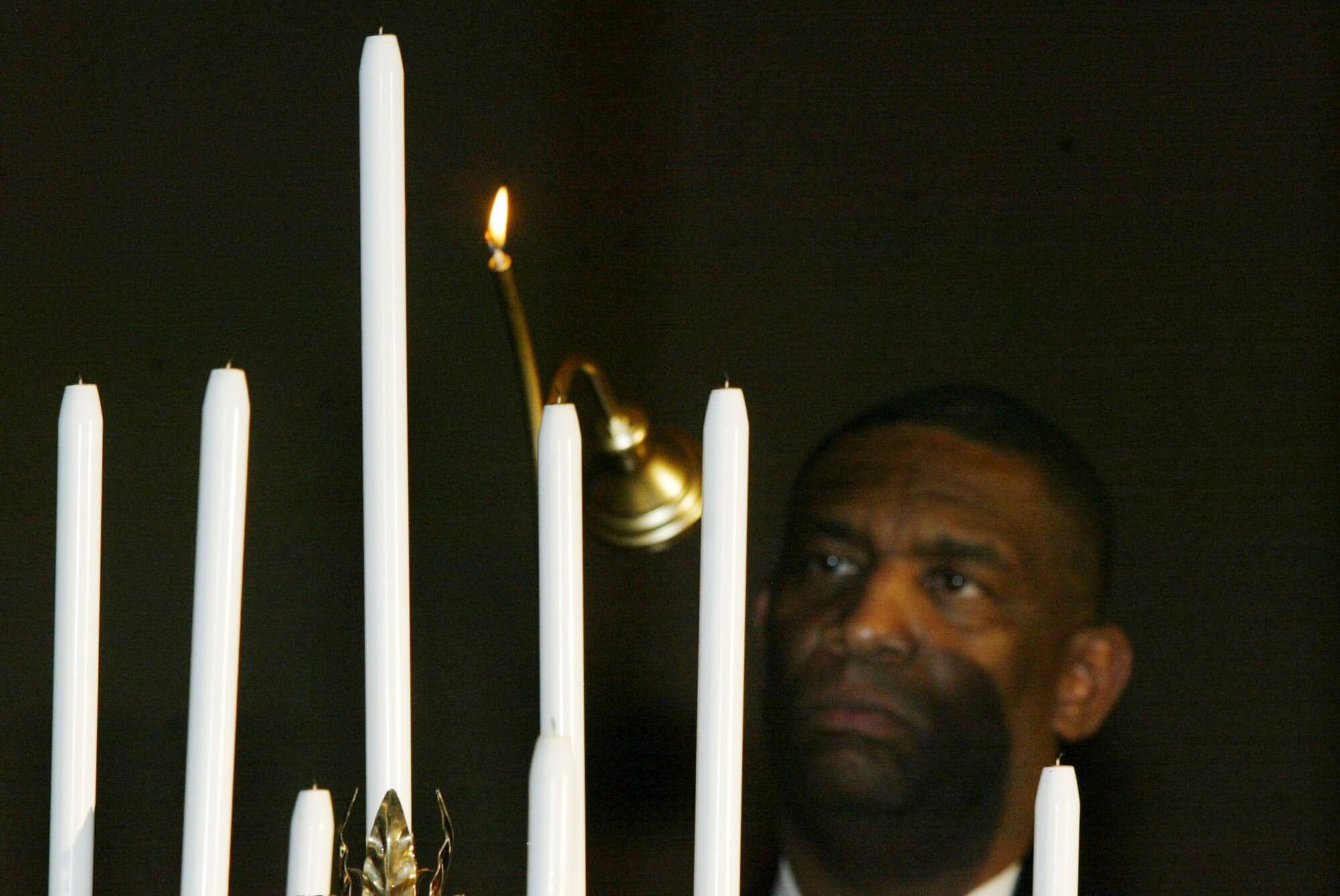 Chief Master Sgt. Gregory Gamble, 22nd Air Force, performs the candle lighting ceremony symbolizing the responsibilities entrusted to Chief Master Sergeants during the 2010 Chief Master Sergeant Induction Ceremony held Jan. 9 at the Renaissance Waverly. Dobbins inducted five Chiefs during the ceremony. (U.S. Air Force photo/Don Peek)