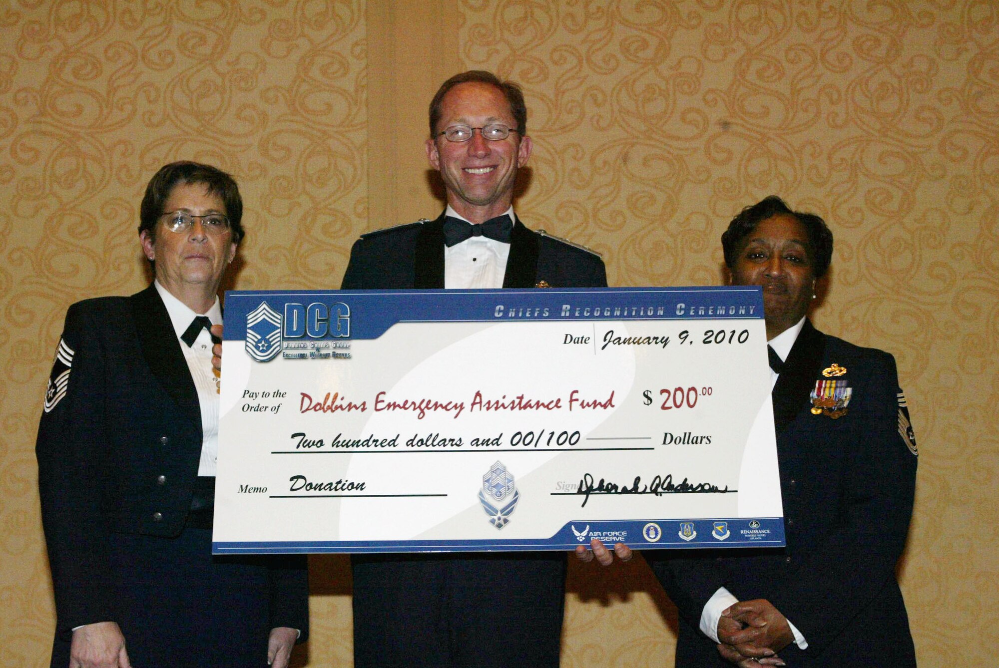 After his keynote address, Maj. Gen. James Rubeor was presented a check to support the Dobbins Emergency Assistance Fund, as a donation from the Dobbins Chiefs Group during the 2010 Chief Master Sergeant Induction Ceremony held Jan. 9 at the Renaissance Waverly. Dobbins inducted five Chiefs during the ceremony. (U.S. Air Force photo/Don Peek)