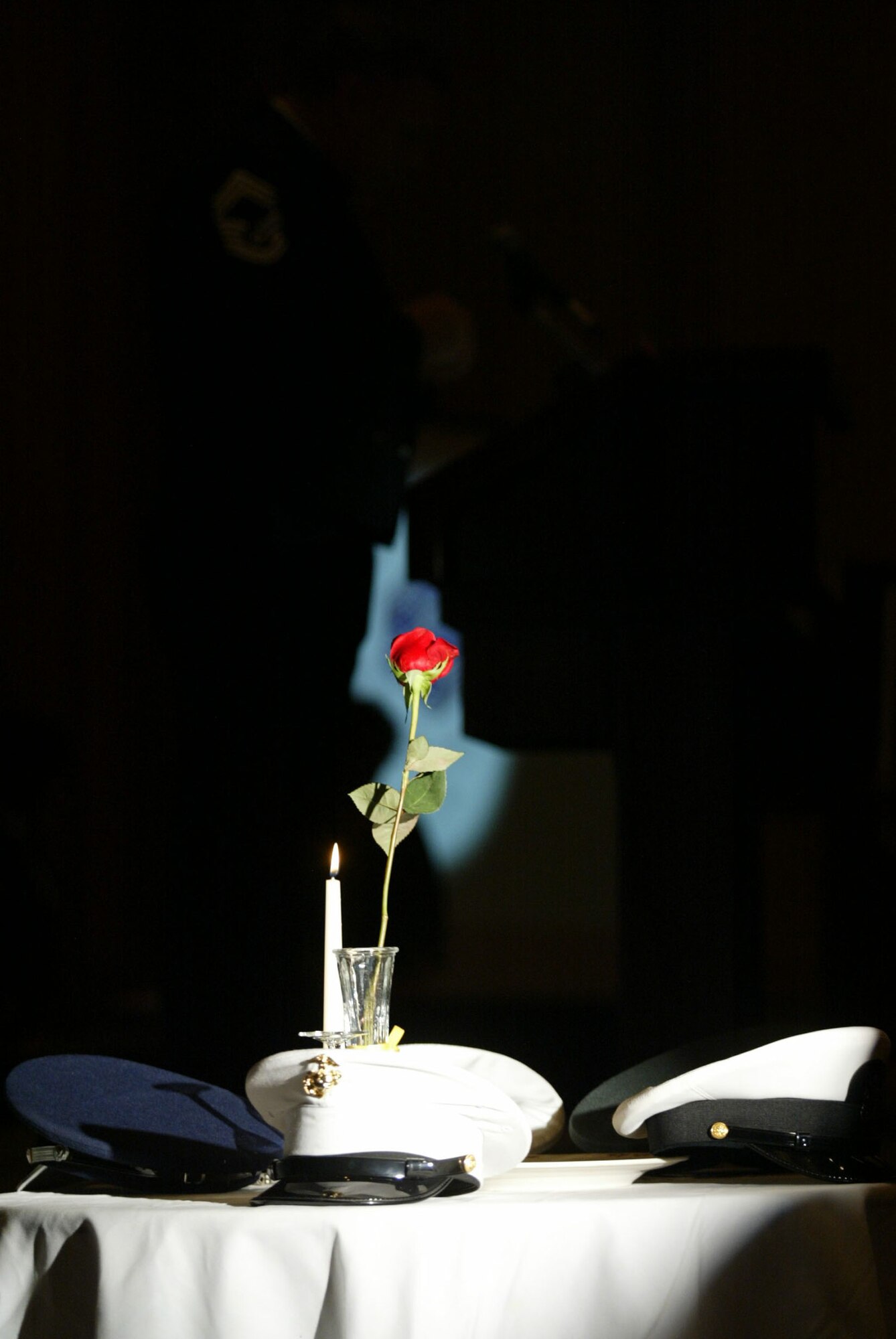 Service hats, a single candle and single rose are arranged on the POW/MIA display table during the 2010 Chief Master Sergeant Induction Ceremony held Jan. 9 at the Renaissance Waverly. Dobbins inducted five Chiefs during the ceremony. (U.S. Air Force photo/Don Peek)