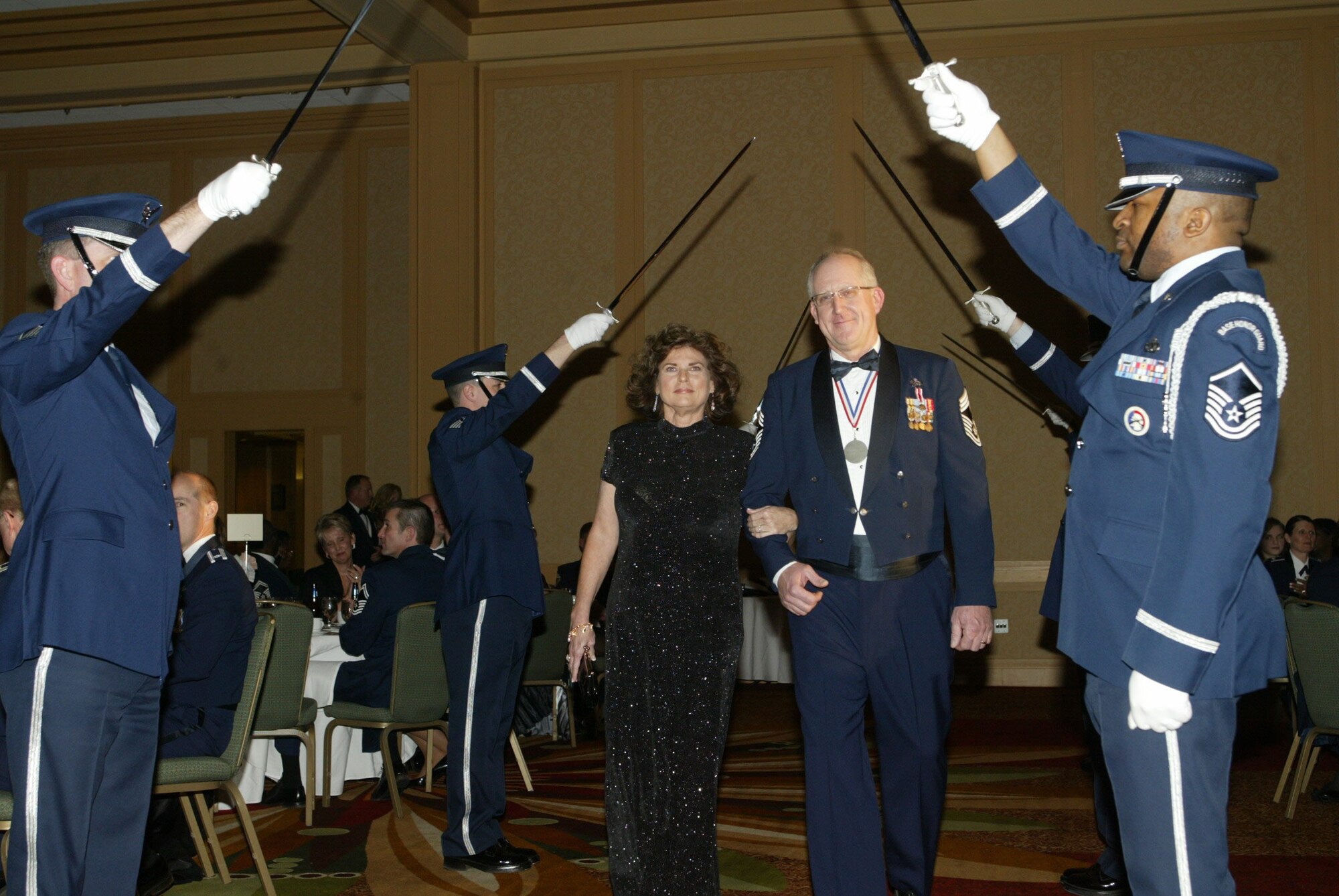 Chief Master Sgt. Paul Anderson, accompanied by his wife Tracie, enters the ballroom marking the beginning of the 2010 Chiefs Recognition Ceremony held Jan. 9 at the Renaissance Waverly. Chief Anderson is the Maintenance Operations Flight superintendent with the 94th Maintenance Group. (U.S. Air Force photo/Don Peek)