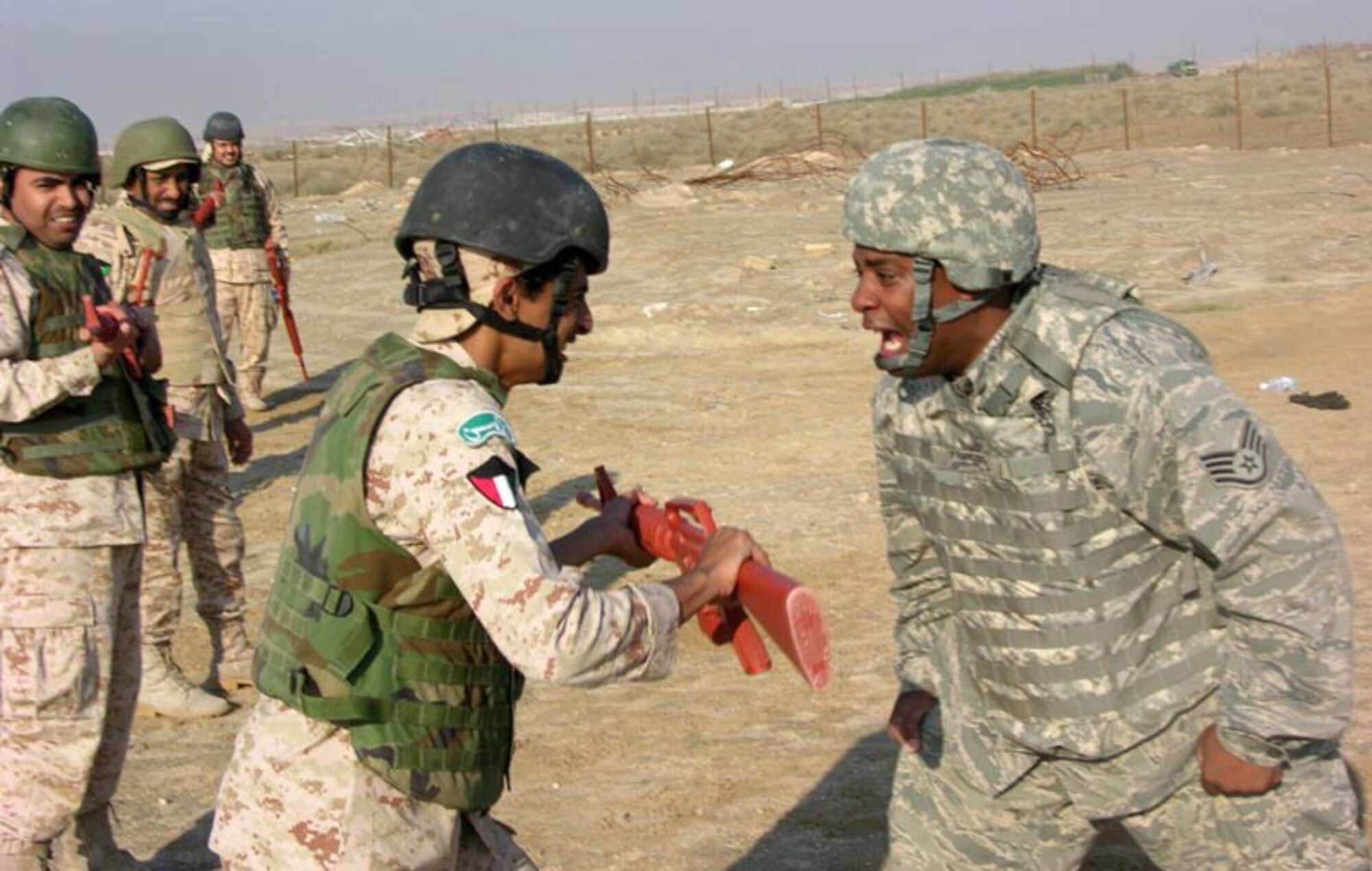 SOUTHWEST ASIA -- Staff Sgt. Ernest Francois, a 387th Expeditionary Security Forces Squadron member deployed from Holloman Air Force Base, N.M., trains with a member of the Kuwaiti military on rifle fighting during host nation training here recently. The training is the first level of training designed to provide a baseline of common core skills for their military personnel performing various operational specialties. (Courtesy photo)