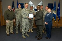 HANSCOM AIR FORCE BASE, Mass. -  Galen Williams, 66th Air Base Wing safety office director,  accepts a letter of congratulations from Lieutenant General Ted Bowlds,  Electronic Systems Center commander, recognizing the 66 ABW Safety Office as having been named the best ground safety program in Air Force Materiel Command.  On hand for the event were members of the safety office (from left to right):  Bob Todd, Captain Morgan D’Olympia, Tech Sergeant Shawn Rice, Staff Sergeant Chad Duprey,  Senior Airman Carrie Gueydan,  and Master Sgt Shelley Barton.  (U.S. Air Force photo by Mark Wyatt)