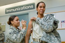 HANSCOM AIR FORCE BASE, Mass. - Airman First Class Akia Austin, 66th Medical Group medical technician gives Army Sergeant First Class Cynthia Shelton,  Army Reserve career counselor, the H1N1 flu vaccination during a flu vaccination clinic at the Medical Group.  The Medical Group was open and providing vaccinations to active duty and retiree personnel.   For more information on flu vaccinations call 781-377-5065. (U.S. Air Force photo by Mark Wyatt)