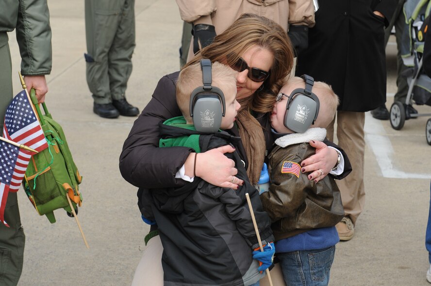 Valerie McClure keeps her sons Tyler and Mason warm while waiting for the arrival of her husband on Seymour Johnson Air Force Base, N.C., Jan. 8, 2009. Capt Philip McClure, 335th Fighter Squadron aircrew, deployed for four-months to Afghanistan in support of Operation Enduring Freedom. (U.S. Air Force photo/Senior Airman Whitney Lambert)