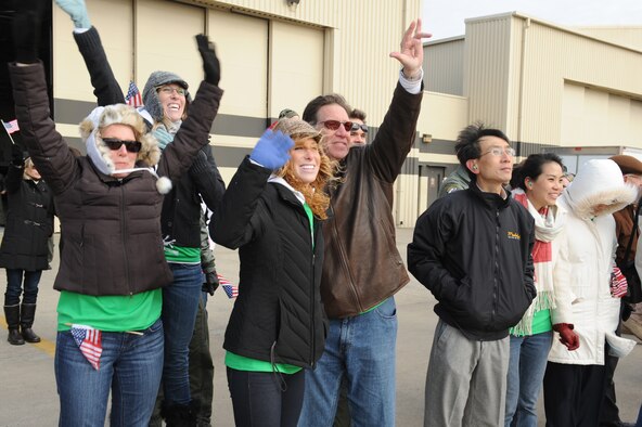Family members of Captain Justin Elliott's, 335th Fighter Squadron pilot, wave as he taxis to a parking spot on Seymour Johnson Air Force Base, N.C., Jan. 8, 2009. Pilots and weapon system operators from the 335th Fighter Squadron and 336th Fighter Squadron flew the 18 returning F-15E Strike Eagles more than 16,000 hours in Afghanistan supporting Operation Enduring Freedom. (U.S. Air Force photo/Senior Airman Whitney Lambert)