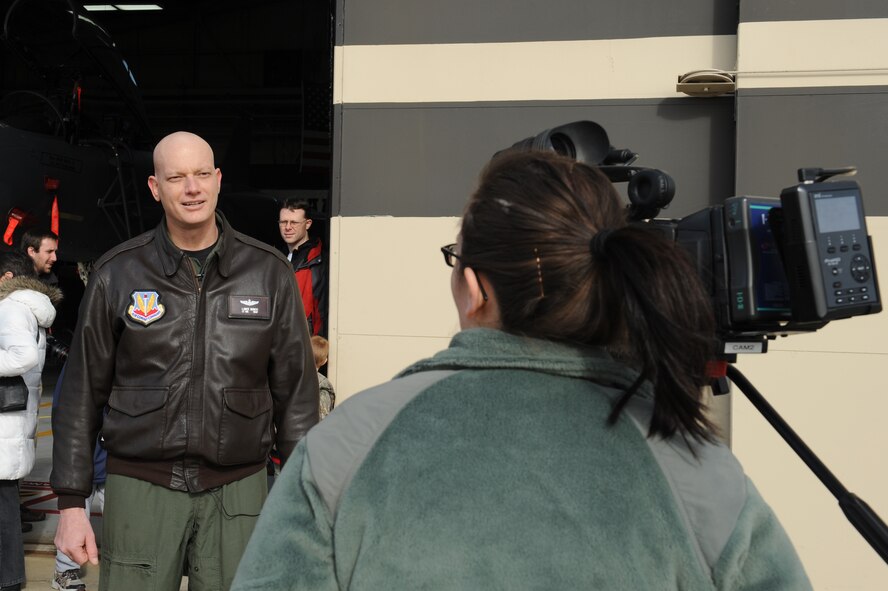 Airman 1st Class Clara Karwacinski, 4th Fighter Wing broadcast journalist, interviews Lt. Col. Lance Bunch, 335th Fighter Squadron commander, about the F-15E Strike Eagles returning to Seymour Johnson Air Force Base, N.C., Jan. 8, 2009. During the interview Bunch expressed his pride in the accomplishments of the 335th Fighter Squadron during their deployment. Karwacinski is from Los Angeles and Bunch is from Enid, Okla. (U.S. Air Force photo/Senior Airman Whitney Lambert) 