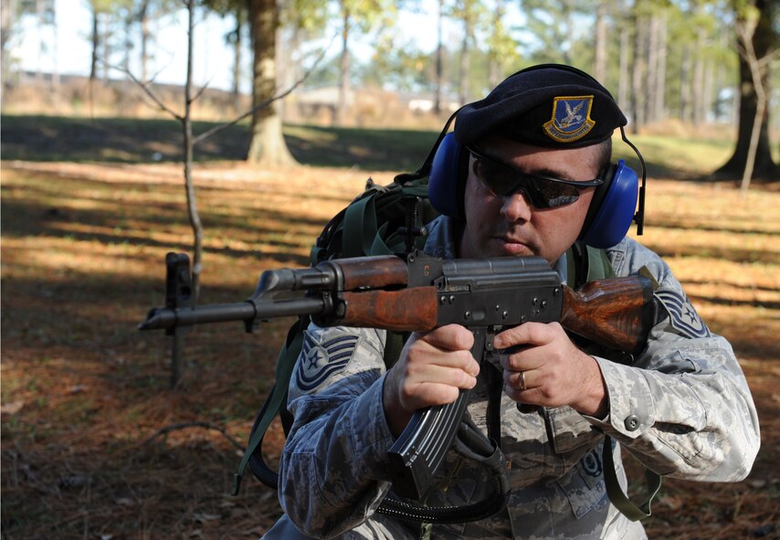 MOODY AIR FORCE BASE, Ga. -- Tech. Sgt. Randy Dauzat, 23rd Security Forces Squadron military working dog section NCO in-charge, demonstrates the realistic sound and appearance of the Ak-47 simulator here Dec. 22. Sergeant Dauzat said that the simulator is used for Military Working Dog training because of its ability to look and sounds like the real world version of the AK-47 assault rifle. (U.S. Air Force photo by Airman 1st Class Benjamin Wiseman)