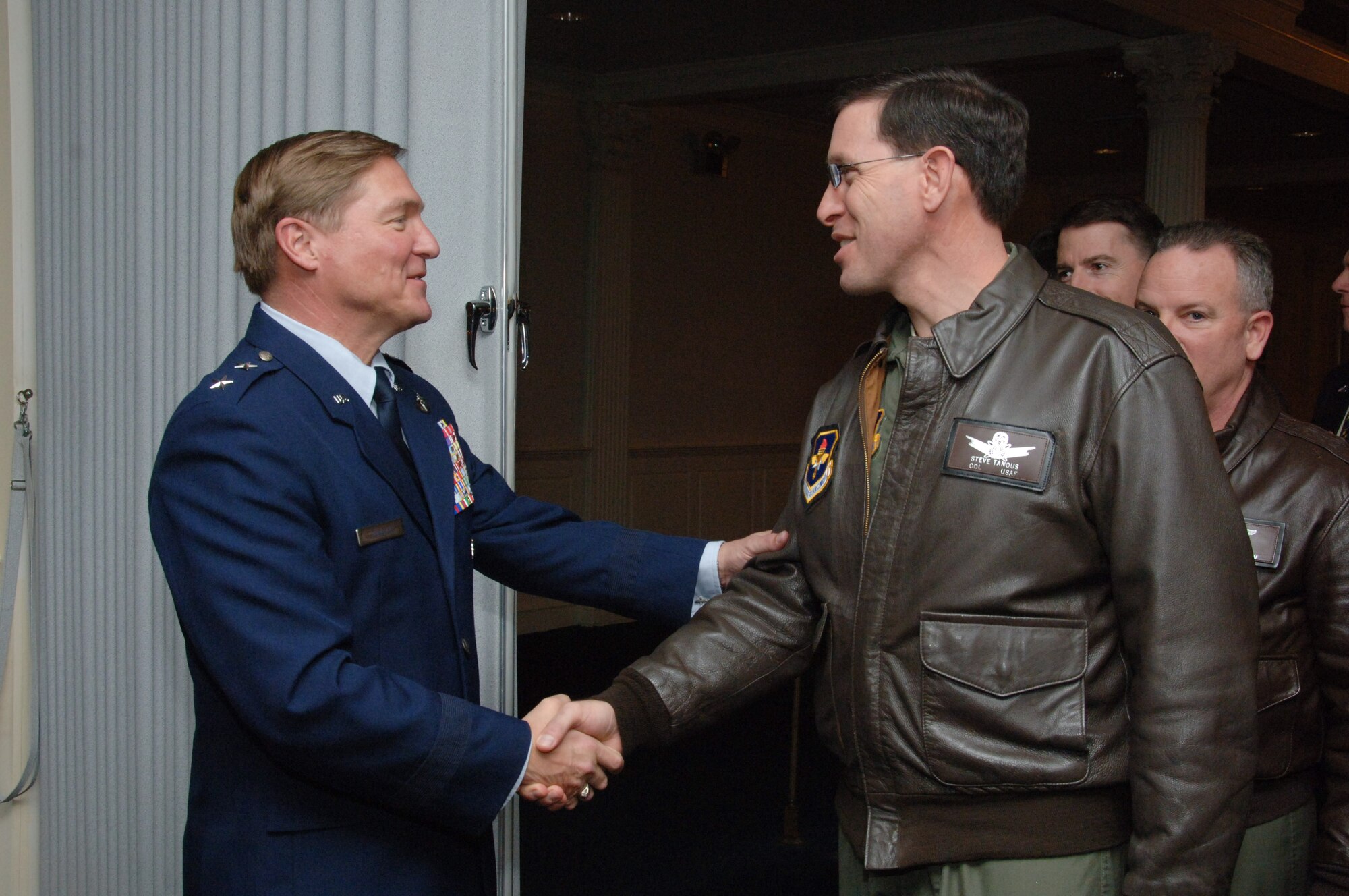 Maj. Gen. Maury Forsyth, LeMay Center commander, receives congratulations from Col. Steve Tanous, Squadron Officer College commander, following the LeMay Center change of command, Jan. 5. Maj. Gen. Forsyth is now responsible for the development and education of Air Force Doctrine.(Air Force Photo by Melanie Rodgers-Cox)