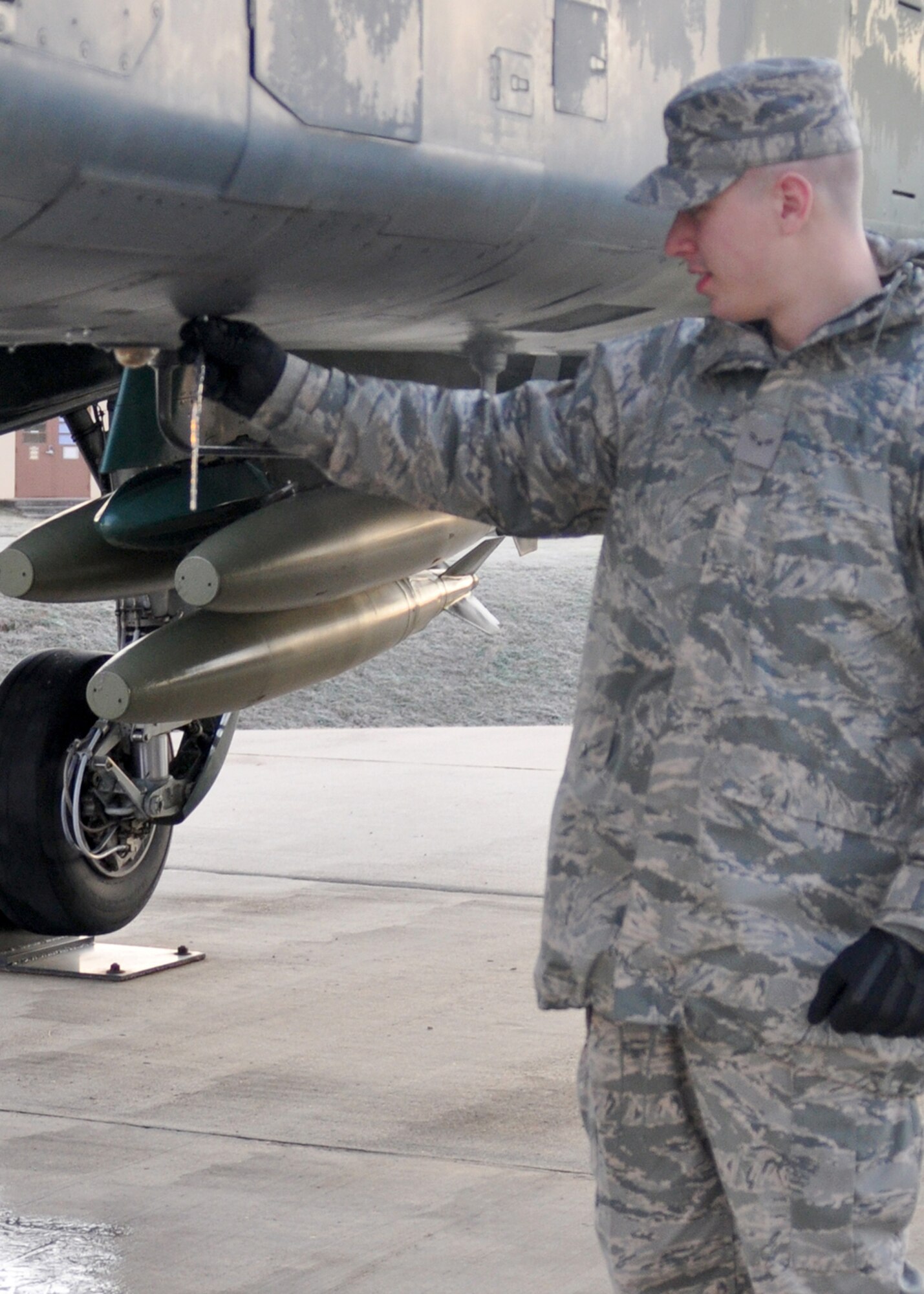 Airman 1st Class Andrew Theis, an aircraft structural maintenance technician for the 917th Aircraft Maintenance Squadron at Barksdale Air Force Base, La., snaps an icicle off of an A-10 Thunderbolt II static display in front of the 917th Headquarters here during his first Unit Training Assembly (UTA) weekend Jan. 9, 2010. Being welcomed to the 917th WG by 13 mph winds, Airman Theis began his training day by braving the 15-degree freeze. Barksdale spent most of the weekend in teen-degree temperatures after a hard freeze warning was issued for most of the Southern United States.  (U.S. Air Force Photo/Senior Airman Crystal Marie Jordan)