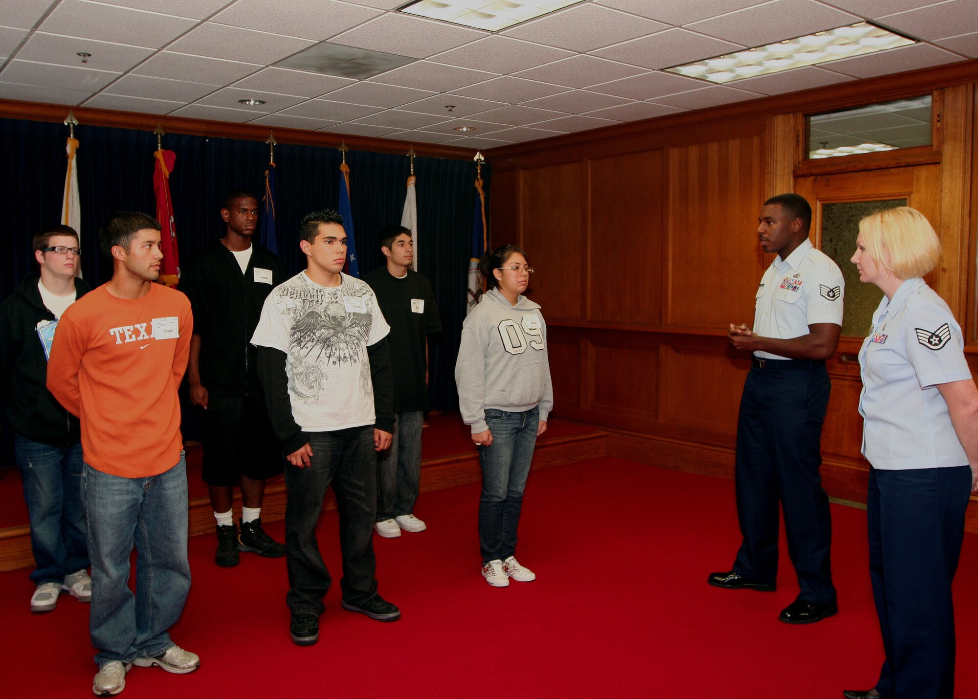 323rd Training Squadron military training instructor Staff Sgt. Bobby Bass addresses Air Force applicants at the Houston military entrance processing station while 341st Recruiting Squadron recruiter Staff Sgt. Cheryl Vercellona listens in. (U.S. Air Force photo/Master Sgt. Thomas Deering) 

