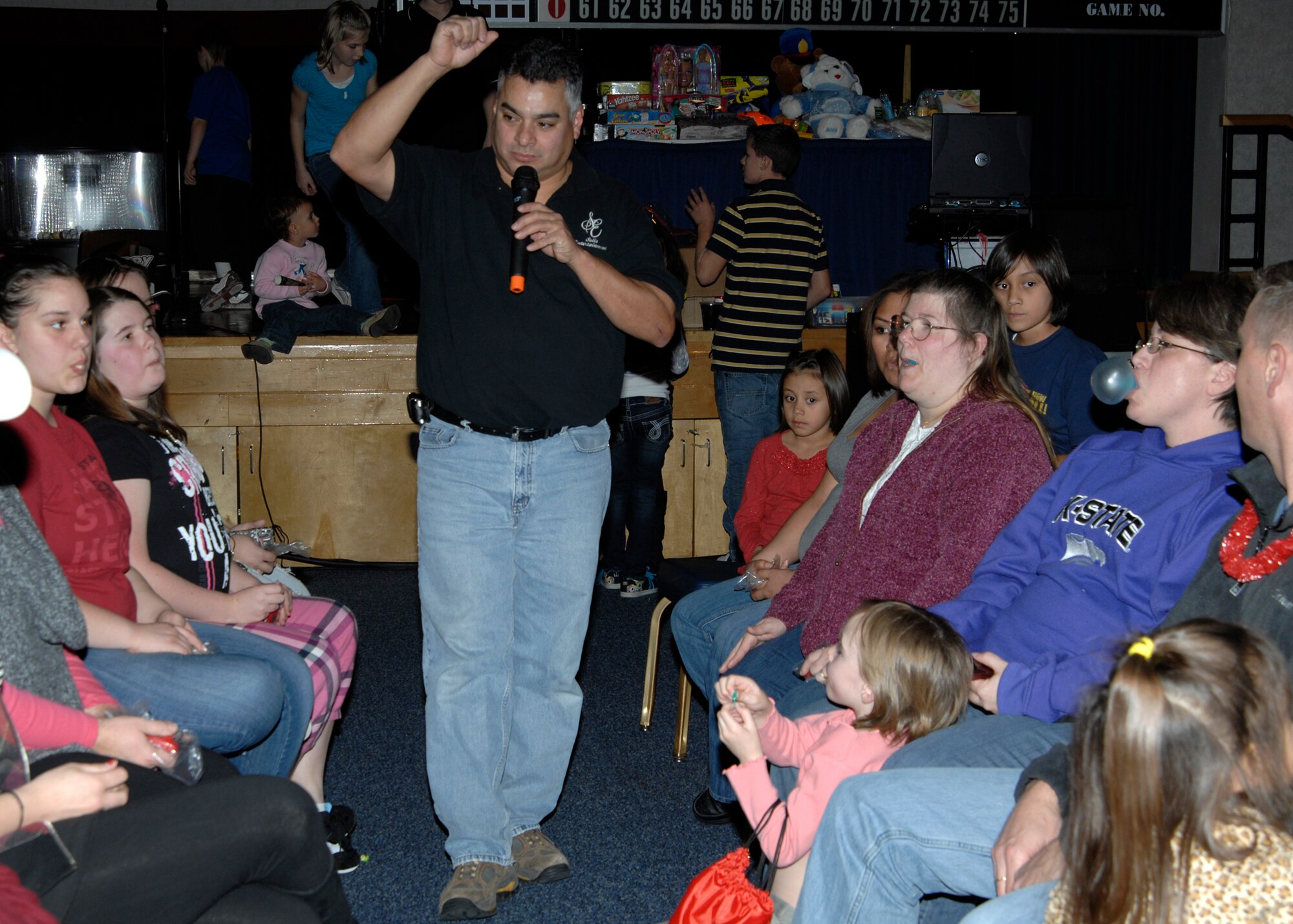 John Solis, civilian entertainer, performs as master of ceremonies during a New Year’s Eve party in the Robert J. Dole Community Center ballroom, Dec. 31, 2009, at McConnell Air Force Base, Kan. Mr. Solis judged party participants of all ages during a bubble gum blowing competition to determine who achieved the largest bubble. (U.S. Air Force/Airman 1st Class Justin Shelton)