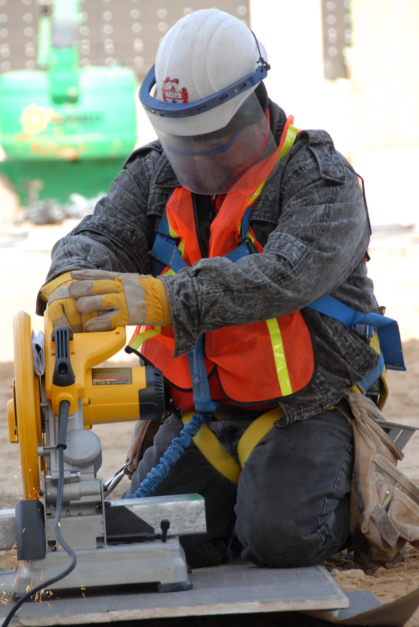 Sparks fly as a construction worker cuts through a piece of metal Jan. 8 at the Joint Strike Fighter Training Facility construction site.  The temperatures and wind chill halted some of the construction activities Jan. 8, but work still continued.  Drills, saws, raised platforms and heavy movers could be heard all around the site.  (U.S. Air Force photo/Samuel King Jr.)