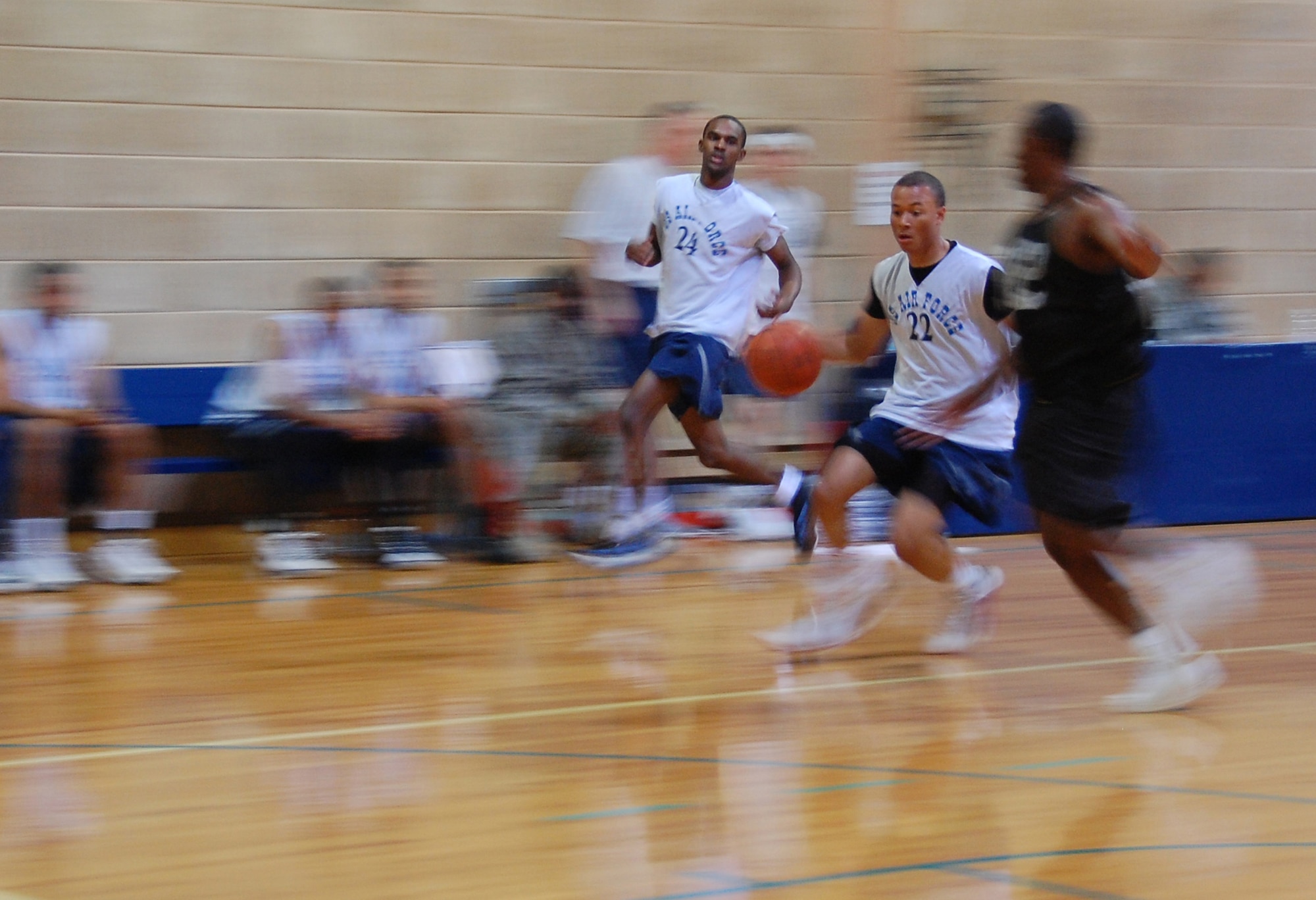 U.S. Air Force Airman Andre Adams, 386th Expeditionary Civil Engineer Squadron, dribbles the ball down court with Airman Dionte Hall, 387th Expeditionary Security Forces Squadron, running close by ready for an outlet pass during a game against U.S. Army Soliders Jan. 10, 2010 at an air base in Southwest Asia. The Air Force beat the Army 44-37. The Soliders are stationed at a logistics support area nearby the air base. (U.S. Air Force photo by Staff Sgt. Lindsey Maurice/Released) 