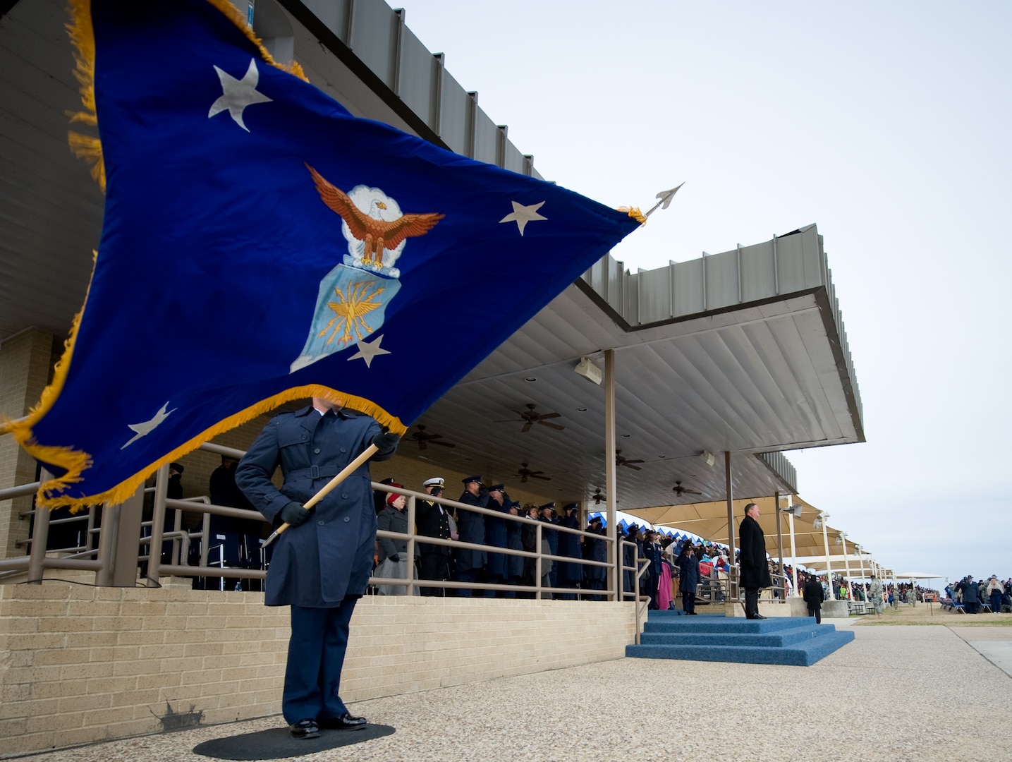 Secretary of the Air Force Michael Donley (top of steps), stands ready for approaching flights to pass in review during a Basic Military Training graduation ceremony Jan. 8, 2010, at Lackland Air Force Base, Texas.  (U.S. Air Force photo/Lance Cheung)