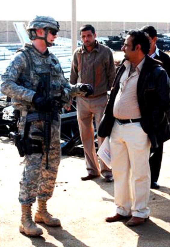 Army 1st Lt. Adam Marquis and Navy Lt. j.g. Christopher Deluzio, both assigned to Task Force Pathfinder, inspect the progress made on an electrical project in Dhi Qar province. U.S. Army photo by Pfc. Aaron Brooks
