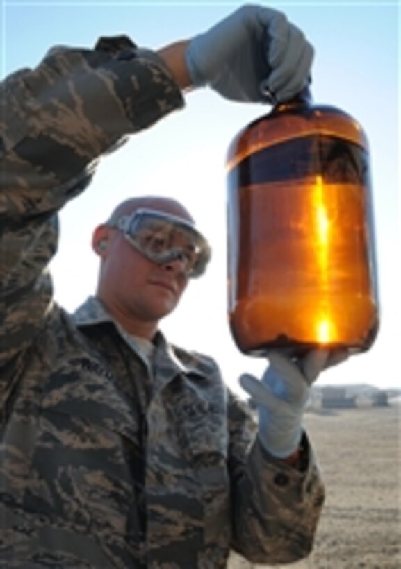 U.S. Air Force Staff Sgt. Craig Wayman, a fuels laboratory technician with the 380th Expeditionary Logistics Readiness Squadron, checks a sample of fuel from a fuels truck during operations at a base in southwest Asia on Jan. 6, 2010.  The 380th Expeditionary Logistics Readiness fuels management flight pumps millions of gallons of fuel every month in support of Operations Iraqi and Enduring Freedom and Combined Joint Task Force-Horn of Africa.  