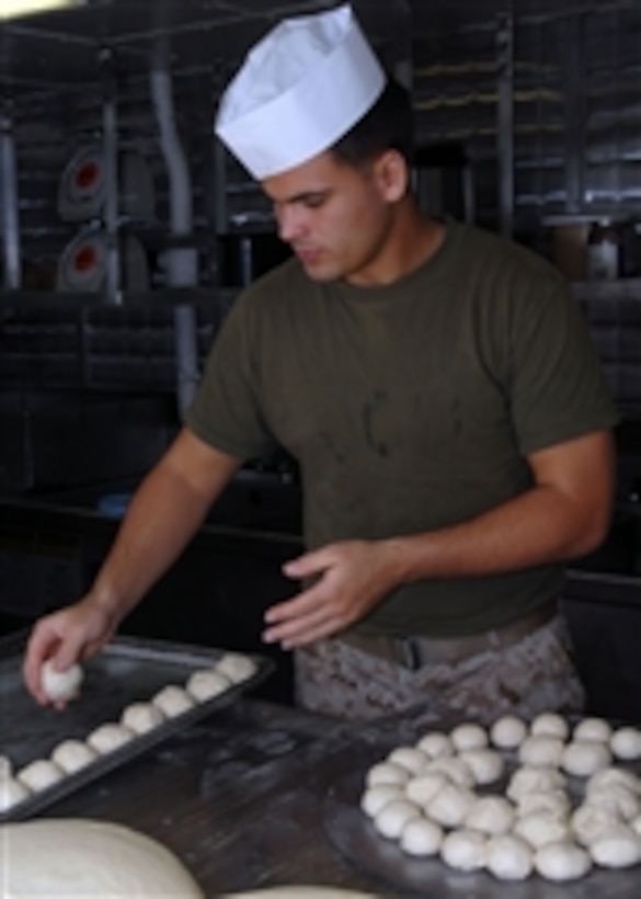U.S. Marine Corps Lance Cpl. Cody Arundell, attached to the 11th Marine Expeditionary Unit, rolls dough in the bake shop aboard the USS Bonhomme Richard (LHD 6) in the Pacific Ocean on Jan. 7, 2010.  The Bonhomme Richard is the command platform for the Bonhomme Richard Amphibious Ready Group and 11th Marine Expeditionary Unit in the U.S. 5th Fleet area of operations.  