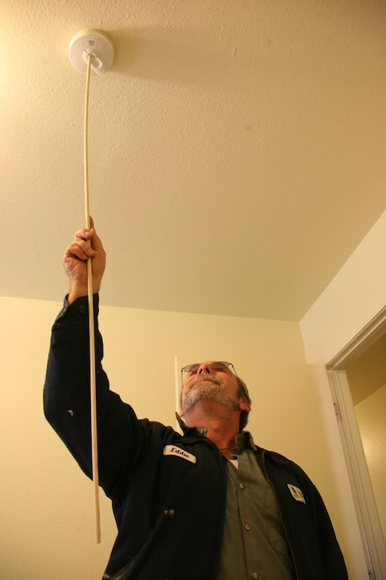 Eddie Anderson, a lead maintenance technician with Atlantic Marine Corps Communities, conducts a serviceability check on a fire alarm in a Nugent Cove home aboard Marine Corps Air Station Cherry Point during a safe start to 2010 campaign for all family housing units, Jan. 11.