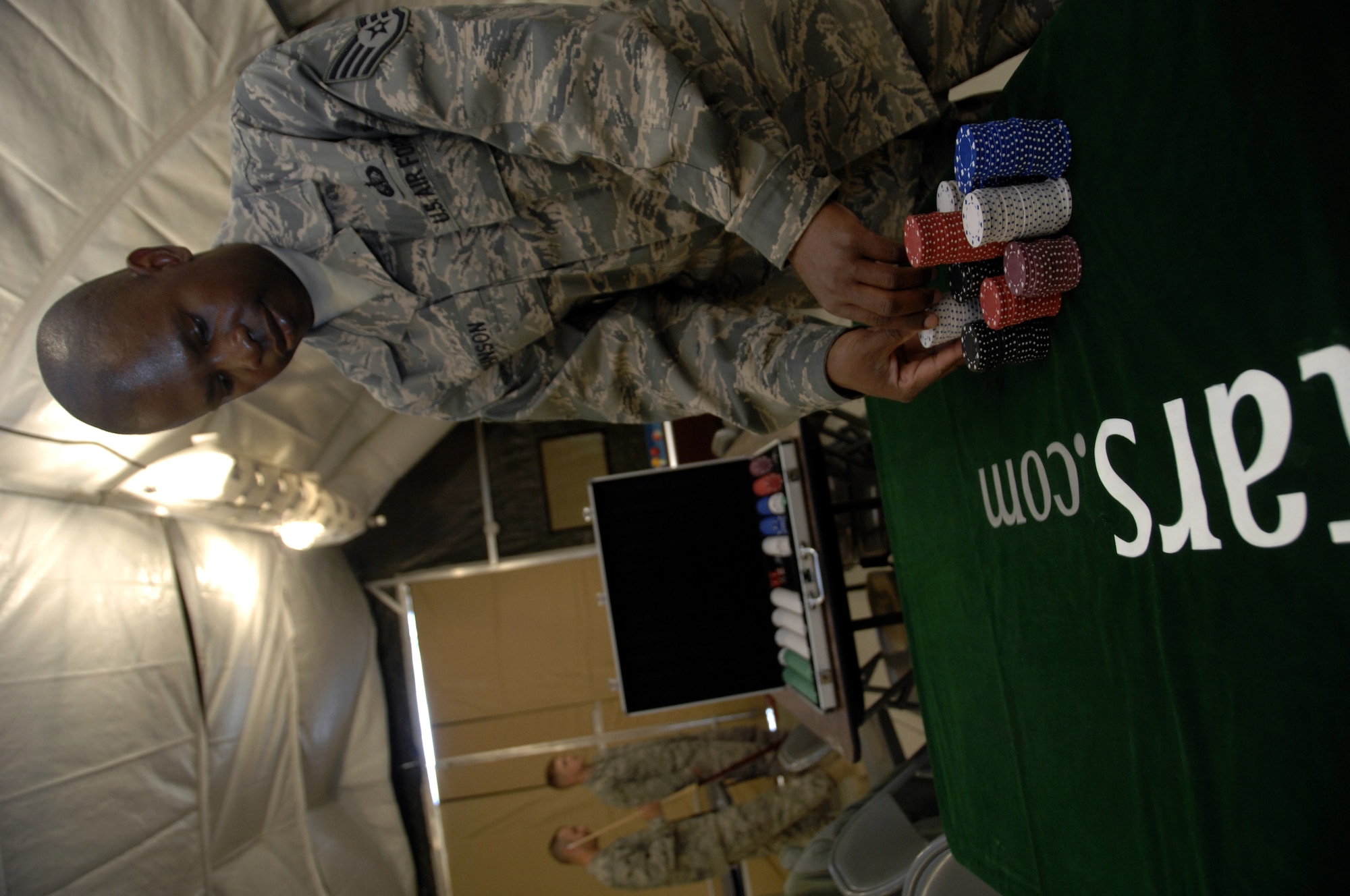 Staff Sgt. Dadrick Johnson stacks poker chips for a Texas Hold'em tournament at the Camp Samek Recreation Tent Jan. 9, 2010. Sergeant Johnson is a Recreation Center clerk for the 451st Expeditionary Force Support Flight from McChord Air Force Base, Wash. (U.S. Air Force photo/Senior Airman Timothy Taylor/Released)