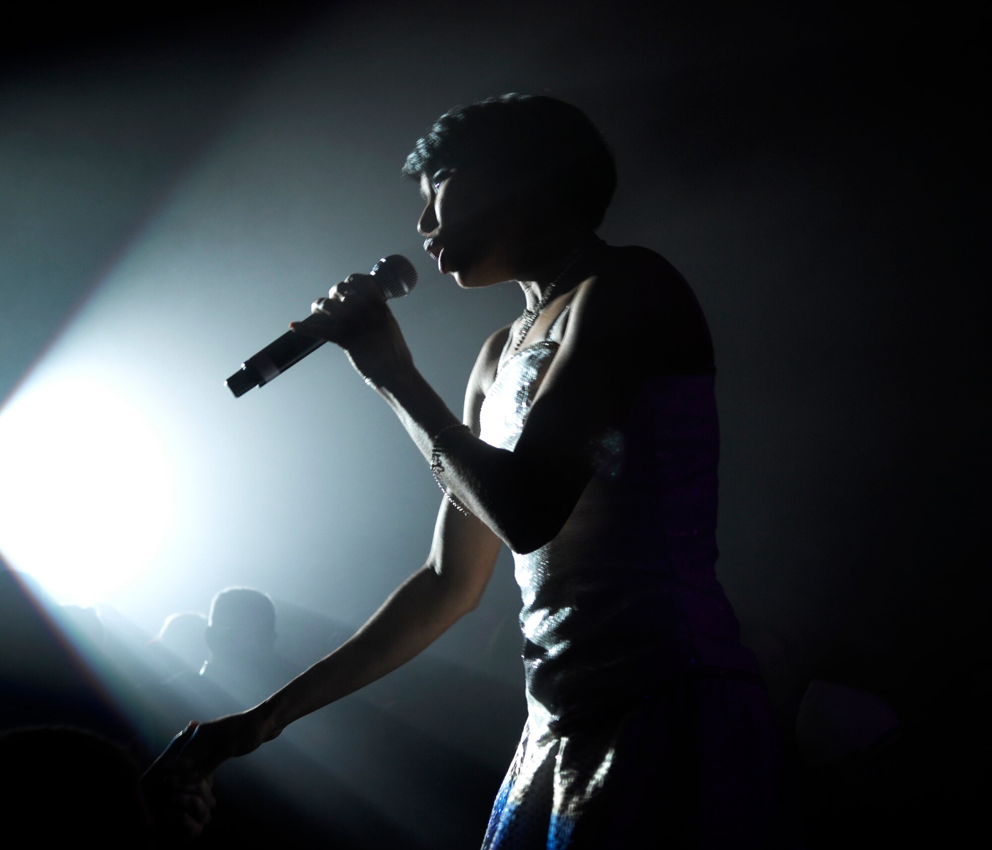 ELMENDORF AIR FORCE BASE, Alaska -- A Tops in Blues performer sings to the crowd during a show here Jan. 11. The Tops in Blue are the Air Force's premier entertainment showcase. (U.S. Air Force photo/ Airman 1st Class Jack Sanders)